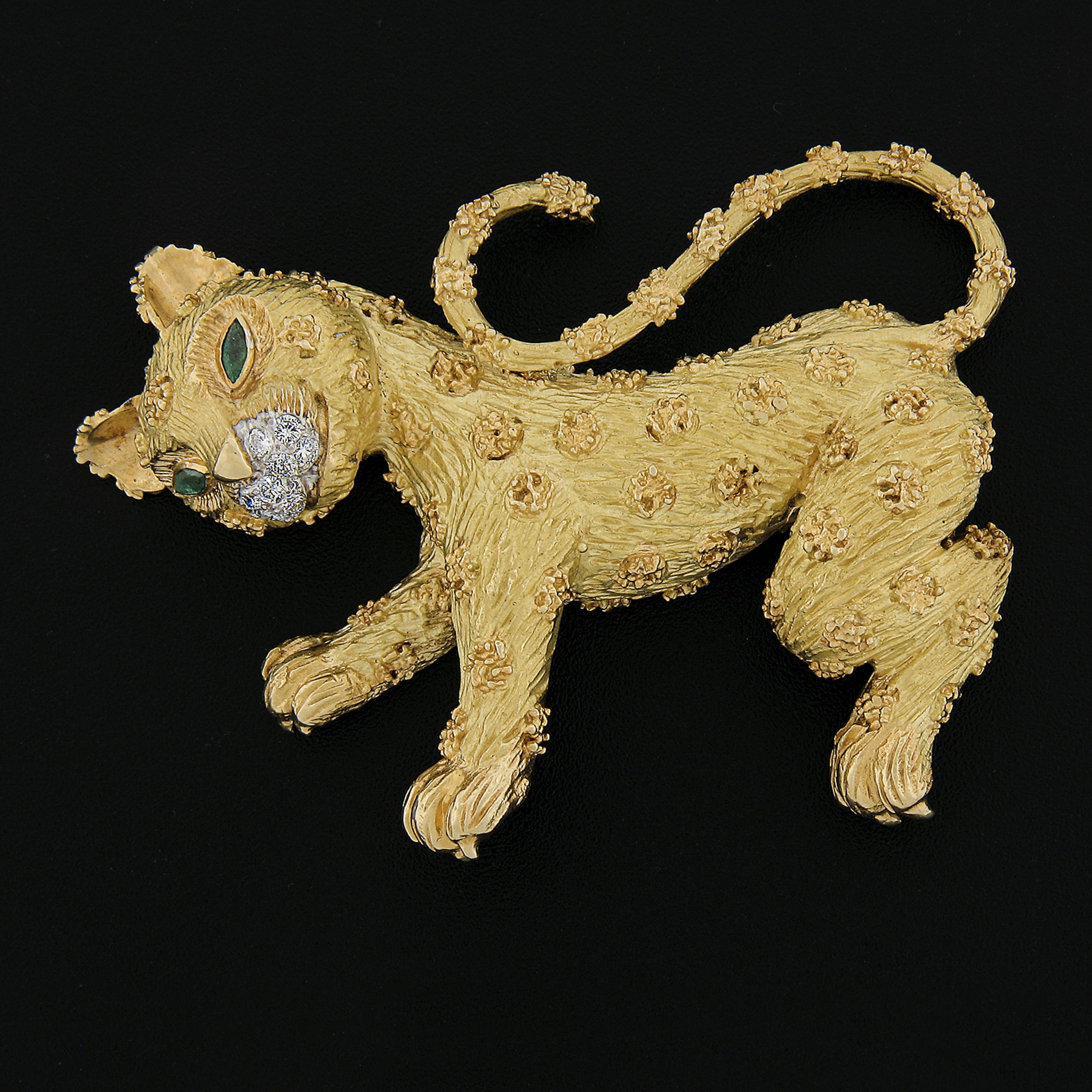 Here we have an Incredible French brooch pin by Robert Wander crafted in solid 18k yellow gold and features leopard cat design. The cat's eyes are set with 2 green emerald marquise cut stones and the nose is covered with fine quality round brilliant