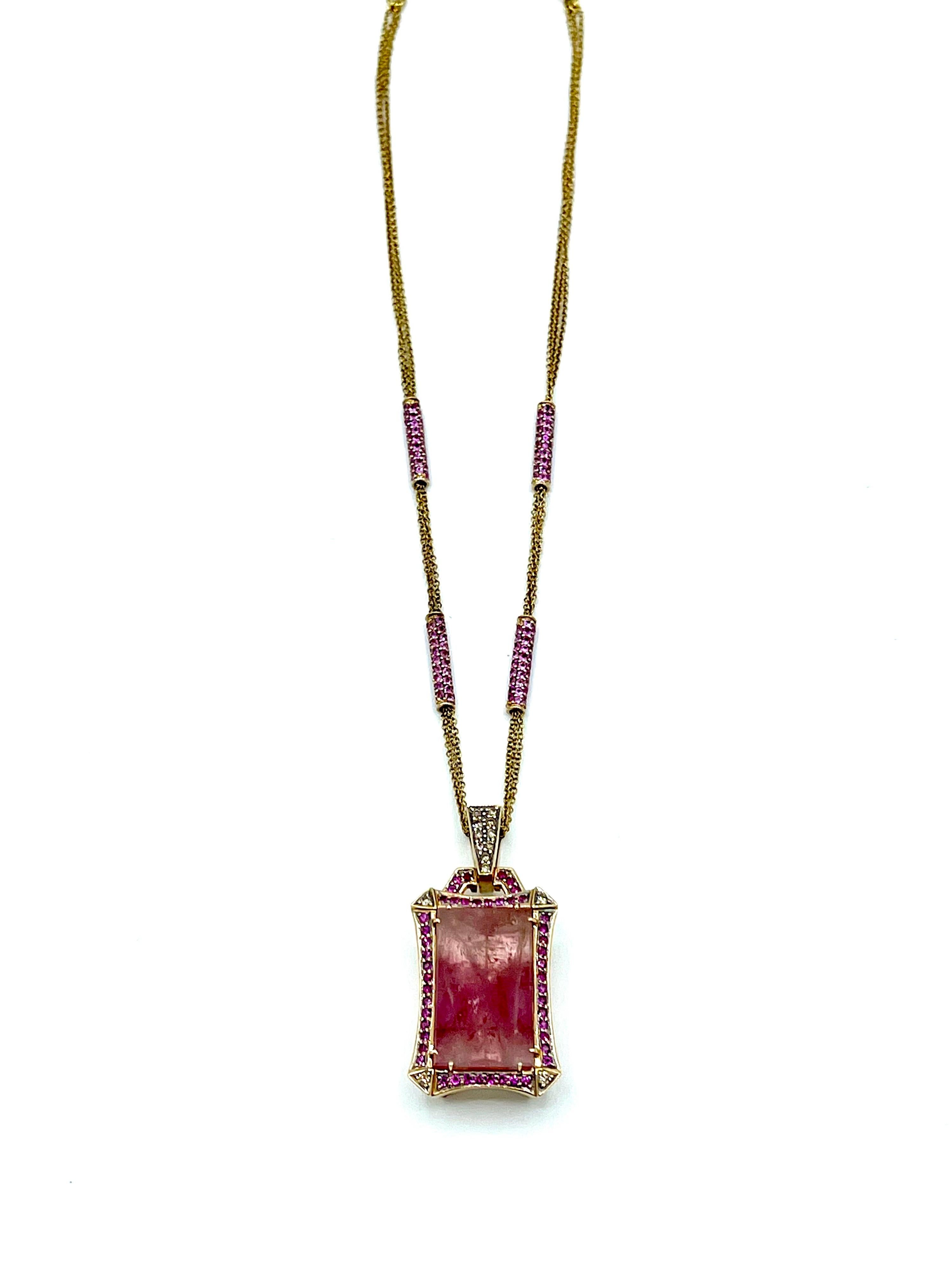 A beautiful emerald cut 35.17 carat Pink Tourmaline pendant necklace.  The Tourmaline is set in eight prongs, and surrounded by a single row of Rubellite Tourmalines, with light brown Diamond corners, suspended from a light brown Diamond bale in 18K