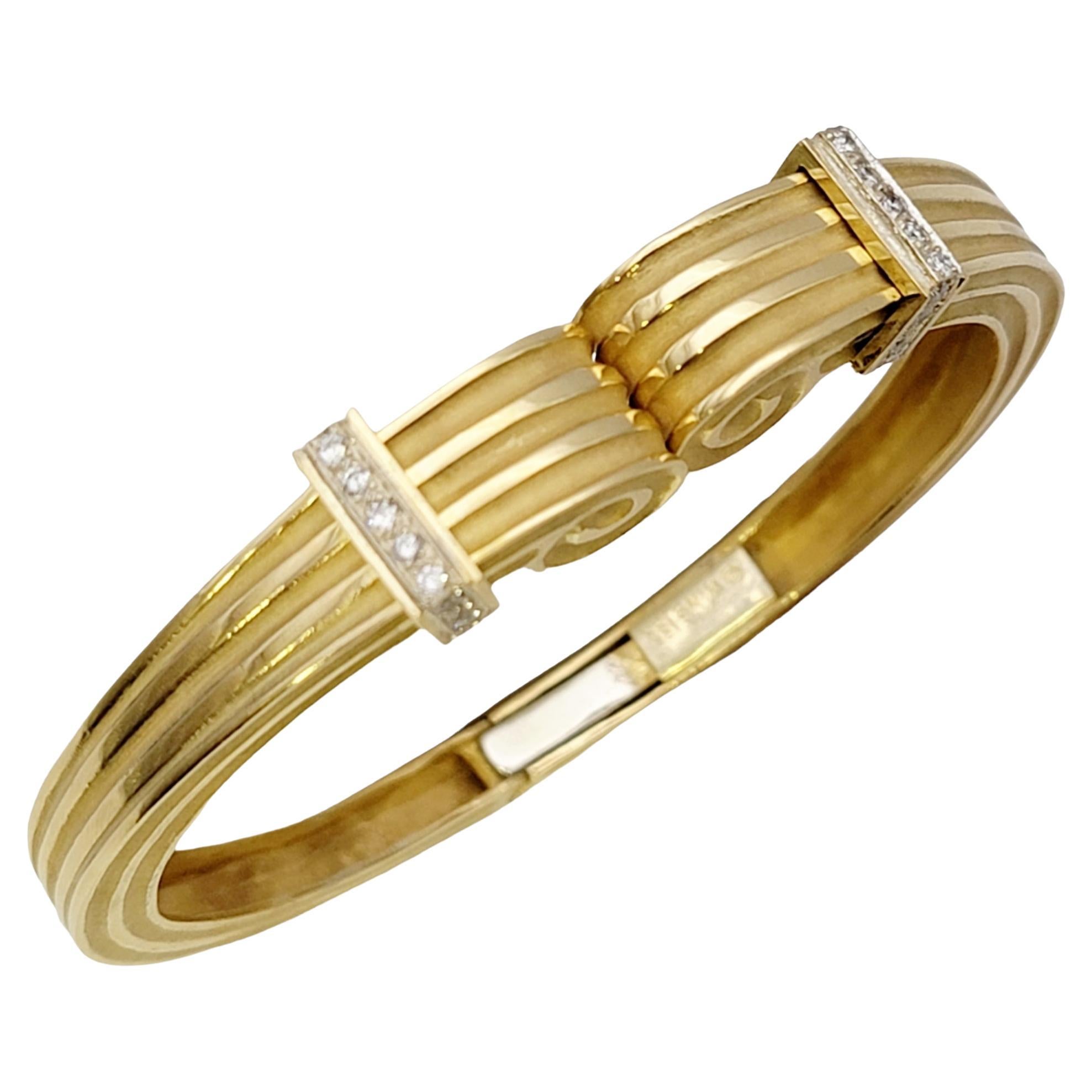 Gorgeous vintage cuff bracelet by designer, Robert Wander. This stunning piece is beautifully textured throughout, with a polished and brushed finish ridged design.  The ends of the bracelet are done in a scroll motif, accented by glittering natural