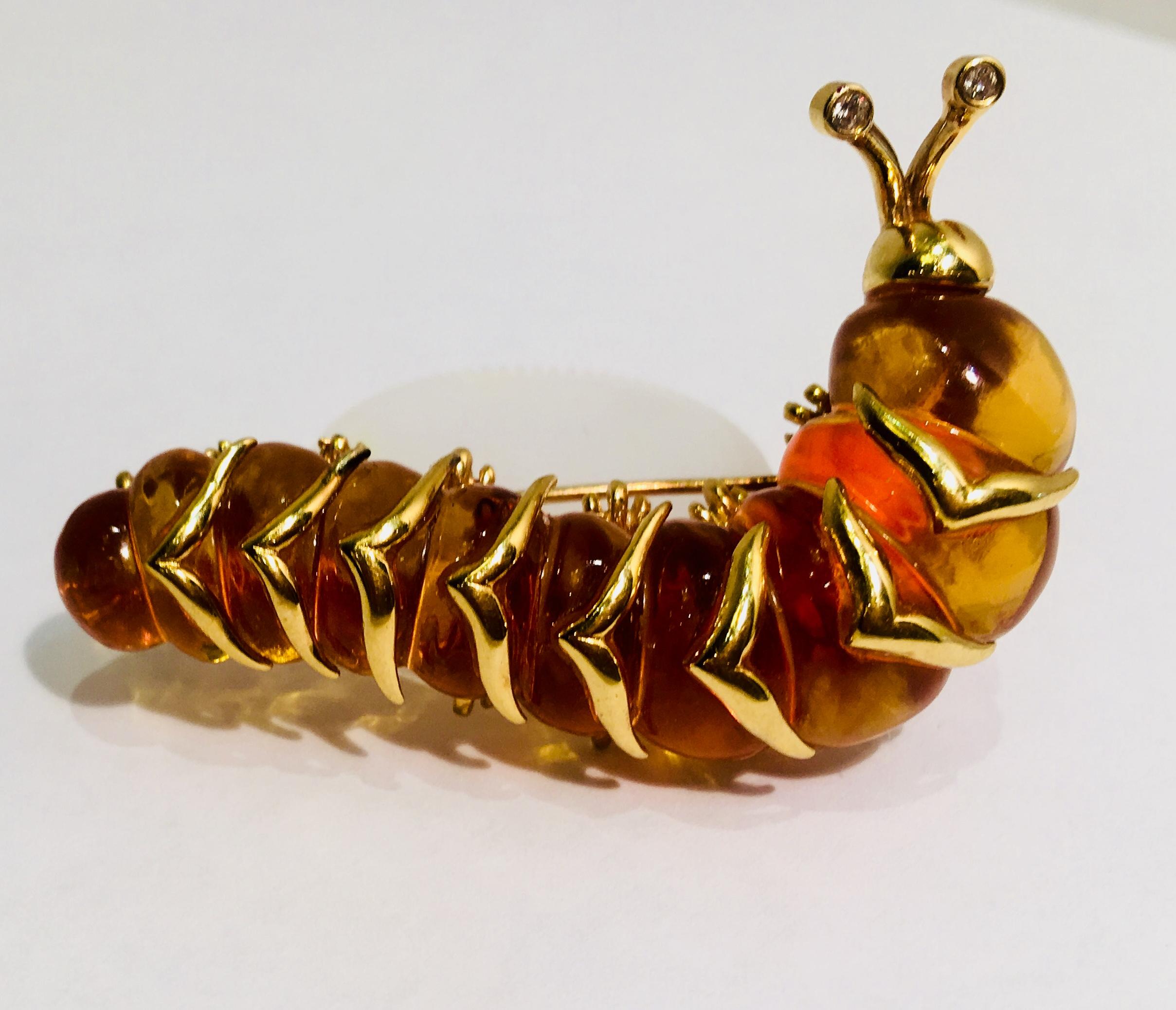 Whimsical, stylized, large as life caterpillar brooch features a hand carved yellow citrine body with 10 bulbous 