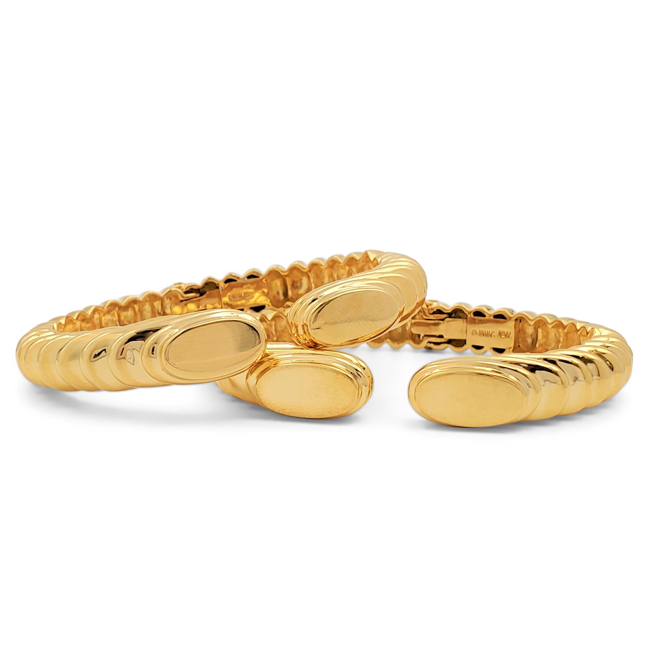Authentic Robert Wander hinged bangle bracelets crafted in ribbed 18 karat yellow gold. Signed WINC, 18K. The bracelets are not presented with the original box or papers. CIRCA 1970s.

Bracelet Size: Will fit up to 6 1/4 inch wrist
Box: No
Papers: No