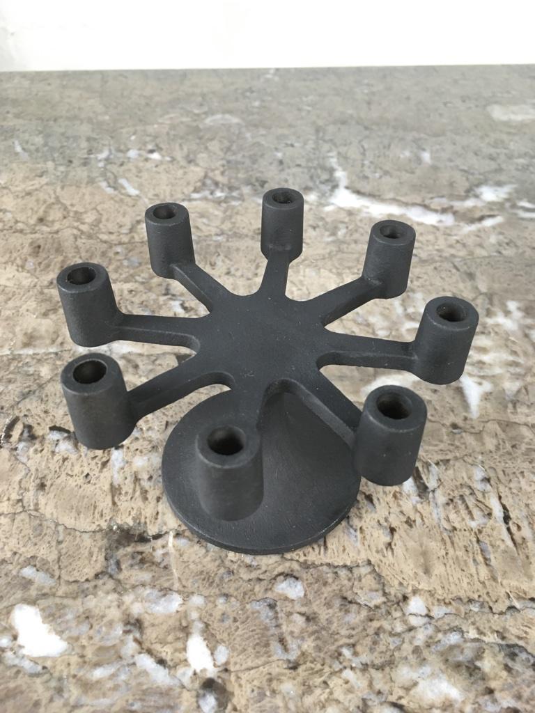 A small CD 55 candelabra in blackened cast iron. Carries eight fine taper (7mm) candles. Comes in its original box. Appears to be unused. Box in great condition too. 

Original foil label to the base. 

   