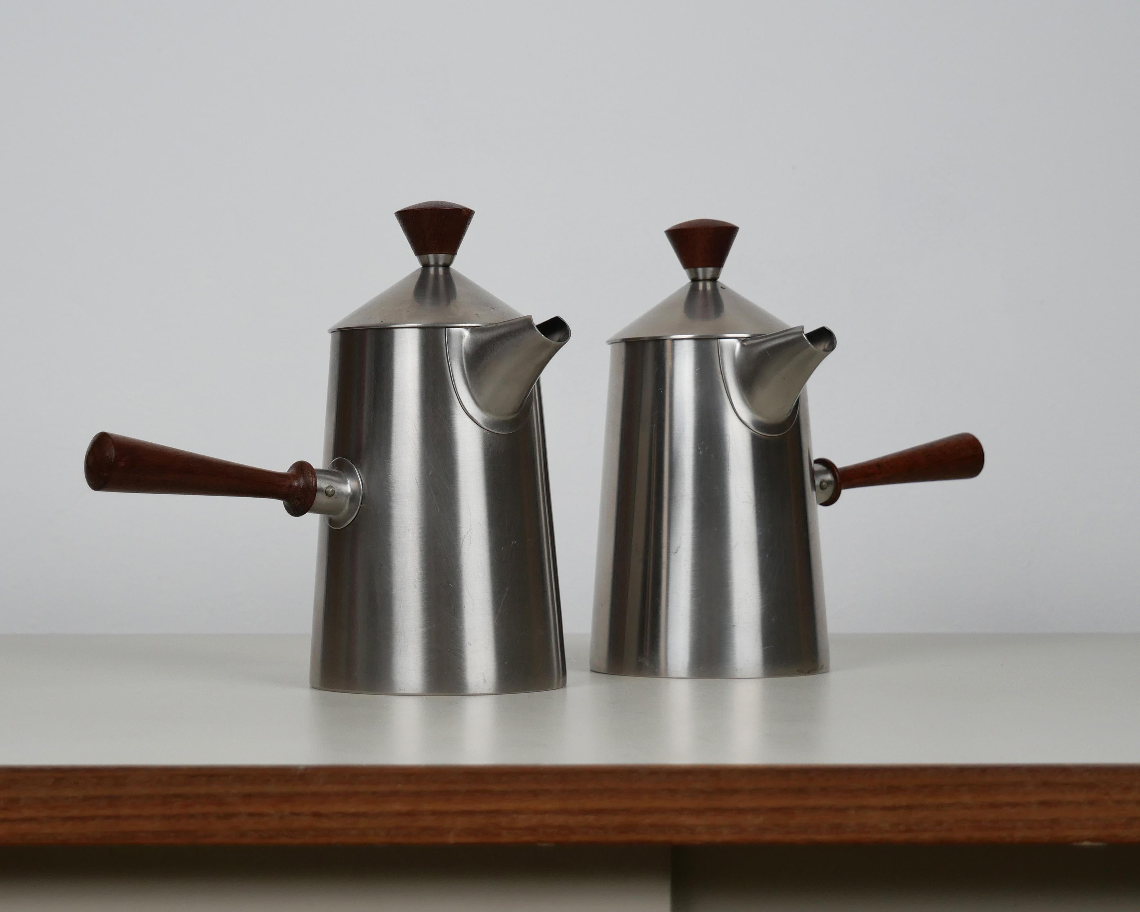 Robert Welch for Old Hall, 1957
Coffee pot and milk jug

Stainless steel with wooden handles
Excellent condition, with only very light marks. Appears generally unused
Makers stamp to underside of each

Dimensions each approx.: diameter 9.5
