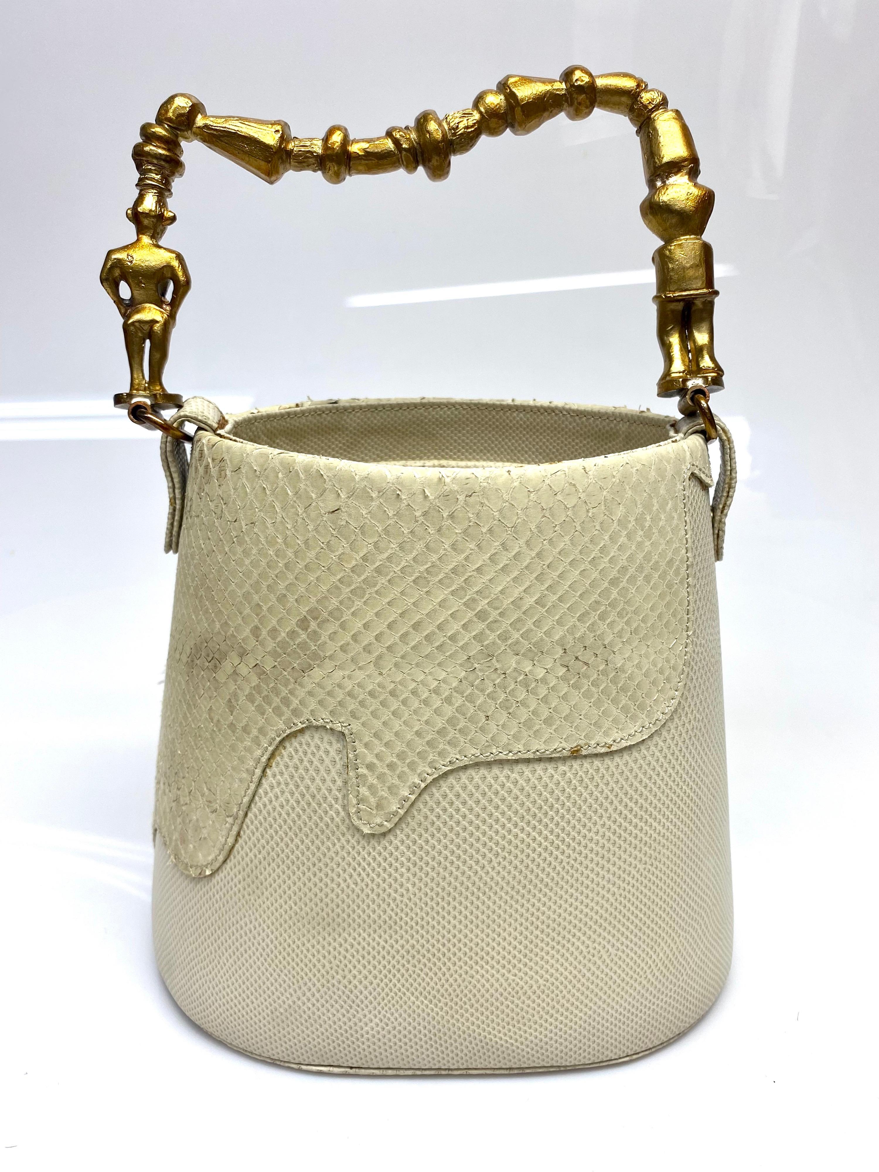This standout piece from Roberta Balsamo is truly iconic. This bag was made for my client and is one of a kind. The bag is Lizard/snakeskin featuring brown and blue rhinestones decorating the handle. This item is in fair condition with signs of wear