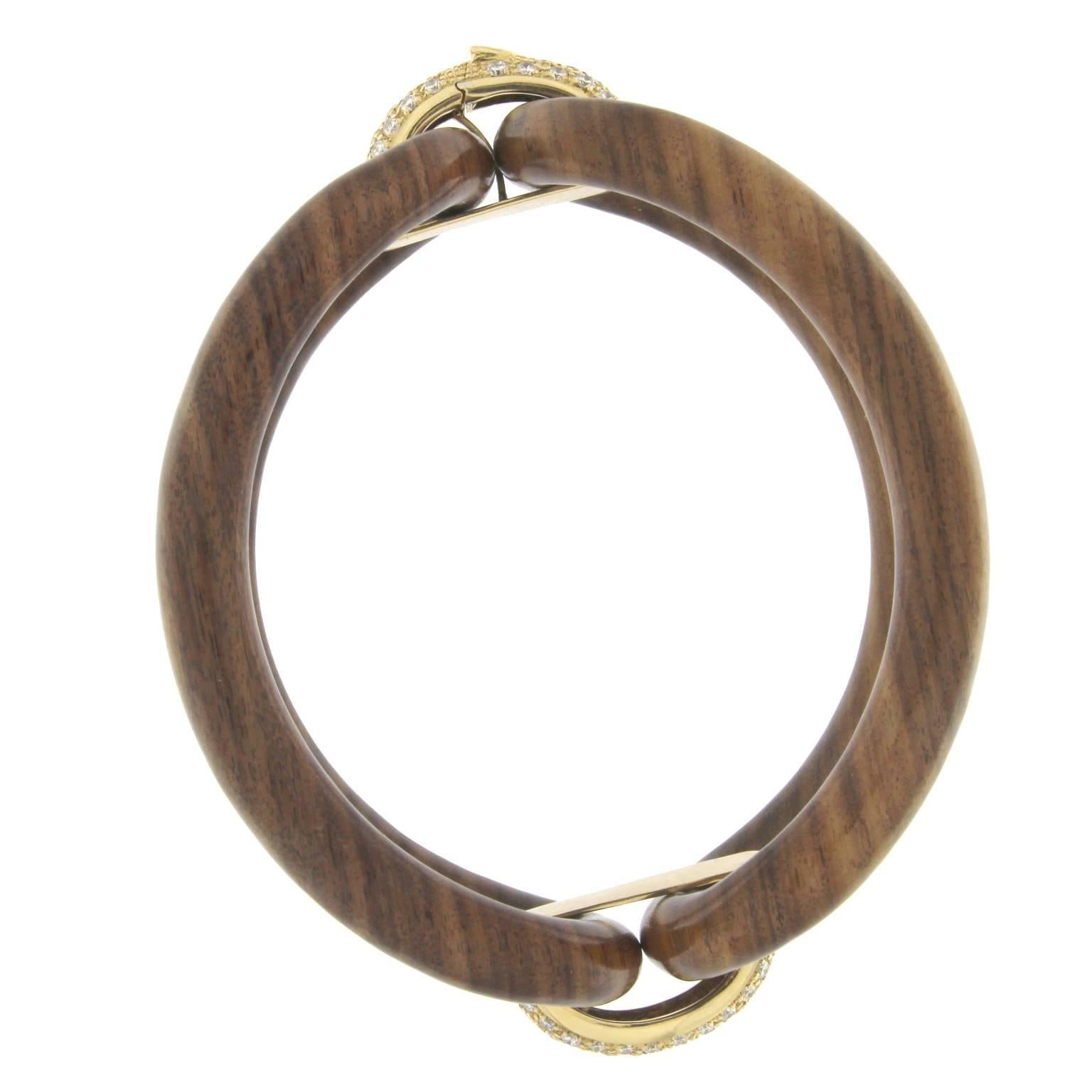 Roberta collection bangle in 18 kt  rose wood  and yellow gold and white diamonds 
The newest and more popular collection of his year

the total weight of the gold is  gr 11.70
the total weight of the white diamonds is ct 1.60 - color GH clarity