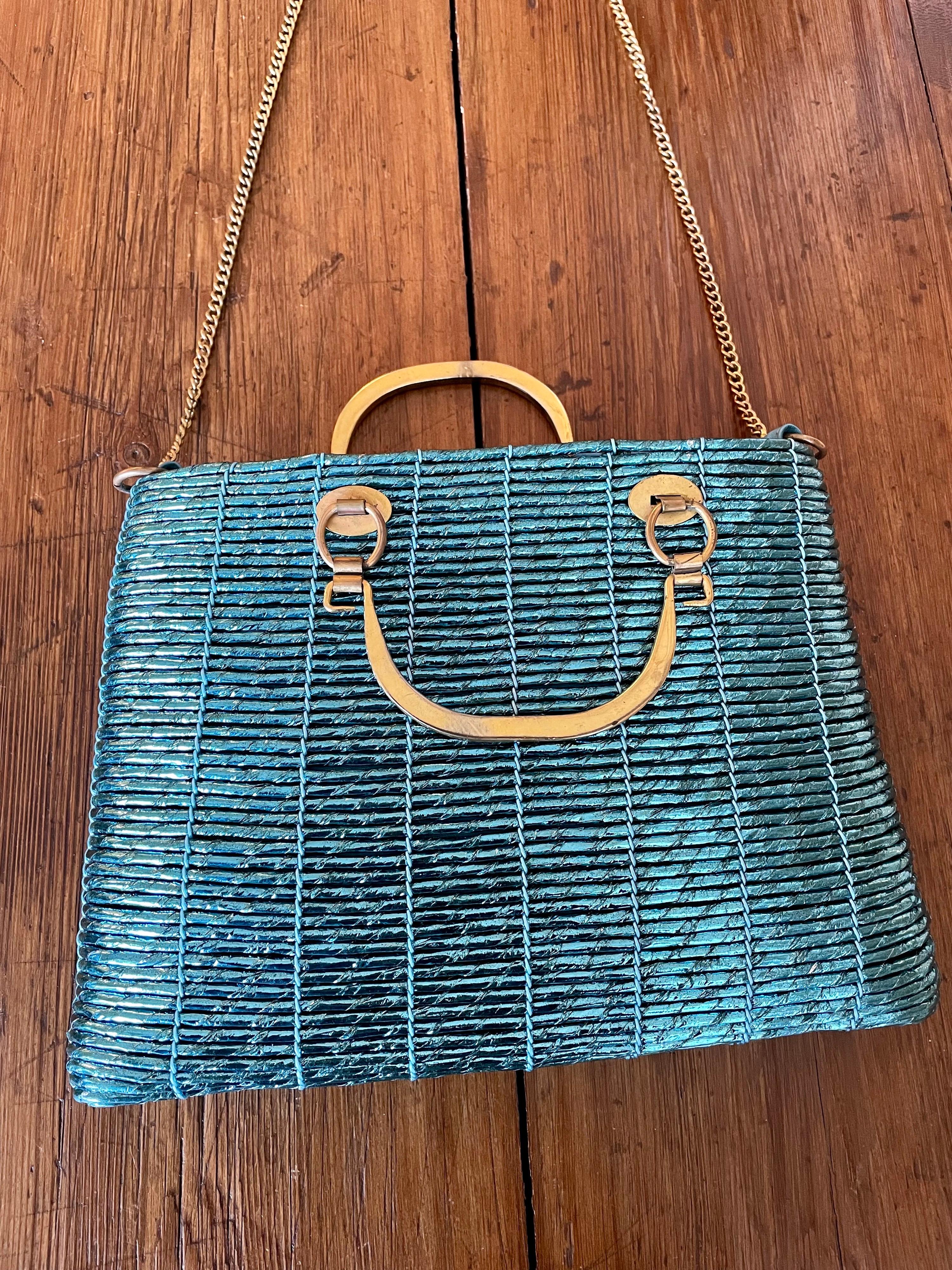 Roberta di Camerino bag. 
Unique. About 50s.
Leather bag covered by turquoise plastic.
Featuring brass handler and golden shoulder strap. It comes with the original dust bag.
Measurements:
Height 20 cm 
Width 28 cm
Depth 4 cm 
Handler 6 cm
Shoulder