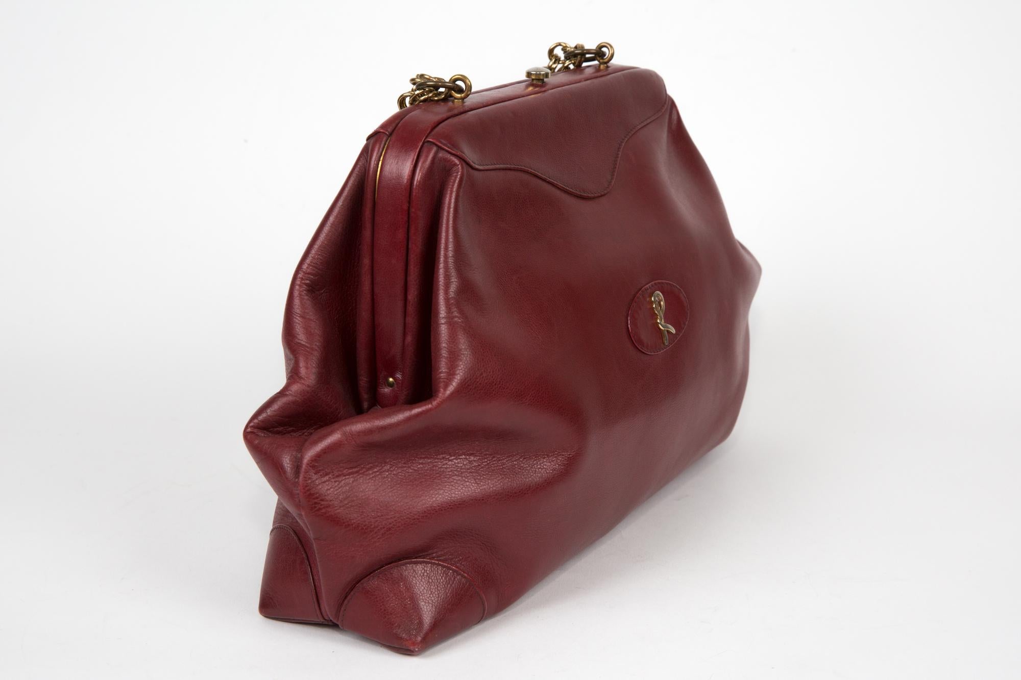Roberta Di Camerino bordeaux leather doctor handbag featuring a top clasp opening, a gold tone adorned front logo 