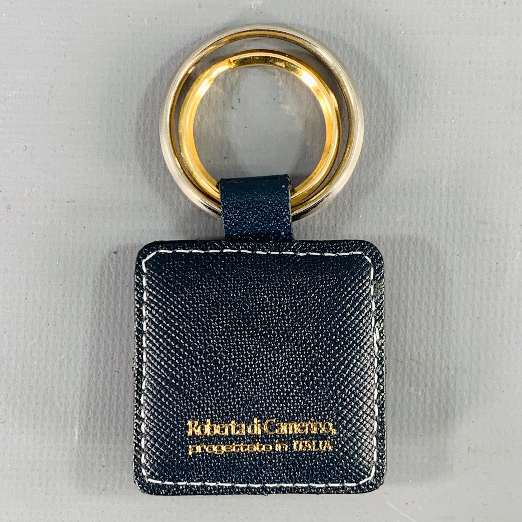 ROBERTA DI CAMERINO keyring
in a multi-color saffiano leather featuring gold tone metal monogram detail, and double metal rings. Comes with box. Made in Italy.Excellent Pre-Owned Condition with Box.1.5 x 1.5 inches 
  
  
 
Sui Generis Reference: