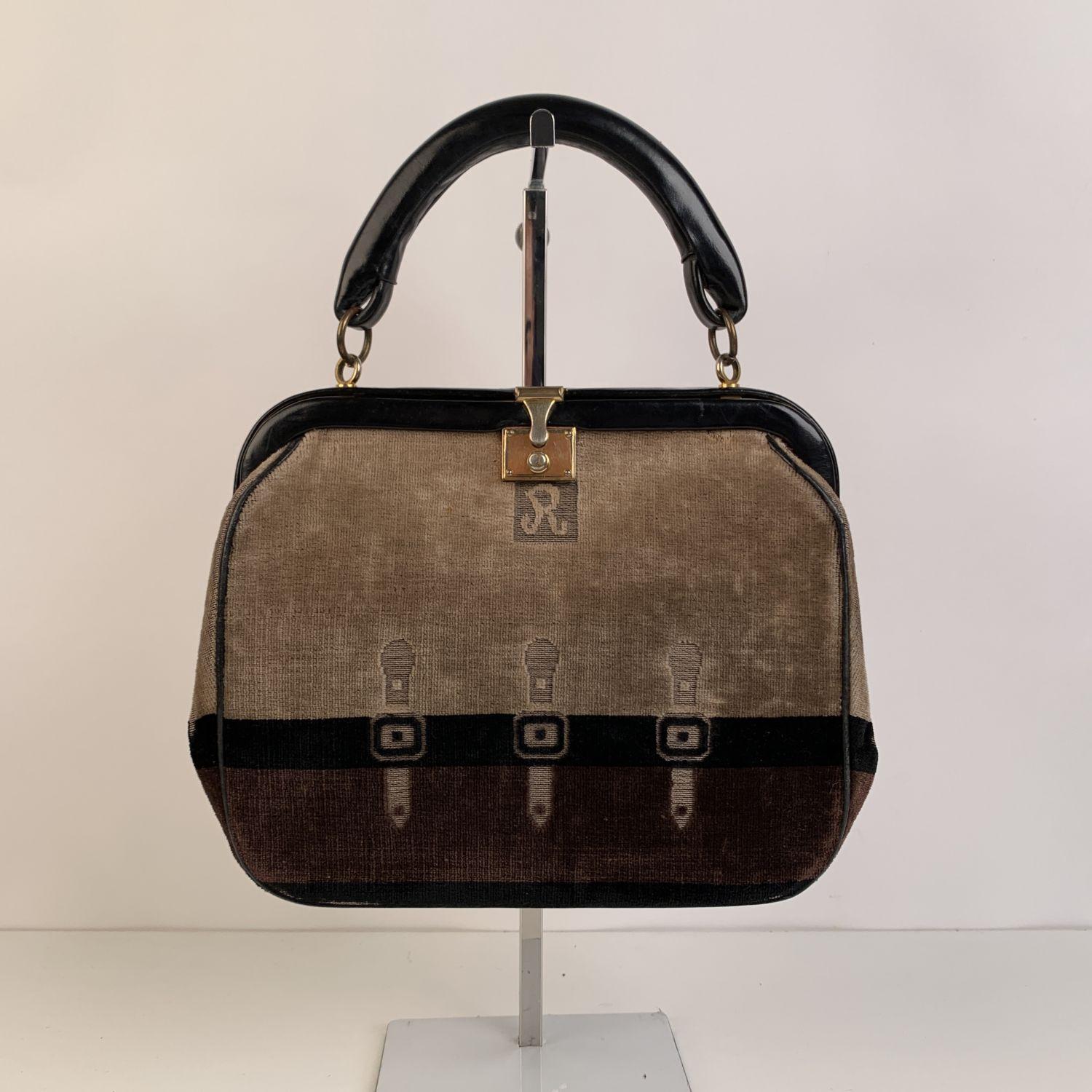 ROBERTA DI CAMERINO velvet handbag. Classic style in brown, black and beige velvet with cut out buckle design on the front and on the back. Gold metal hardware. It features a leather top-handle and a front clasp closure.Leather lining. 2 side open
