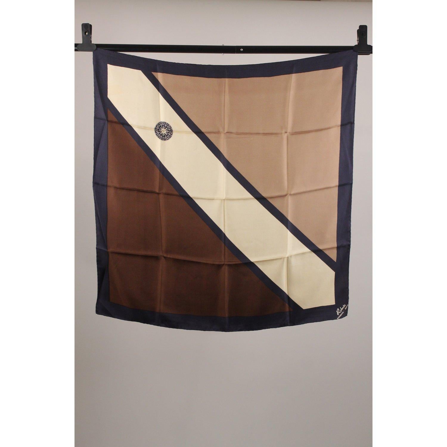 MATERIAL: Silk COLOR: Brown MODEL: Foulard GENDER: Women SIZE: 33 x 33 3/4 inches - 83,8 x 85,7 cm COUNTRY OF MANUFACTURE: Italy Condition C - FAIR A liquid stain/halo on the beige part, a couple of faded marks on the brown part, some pulled threads