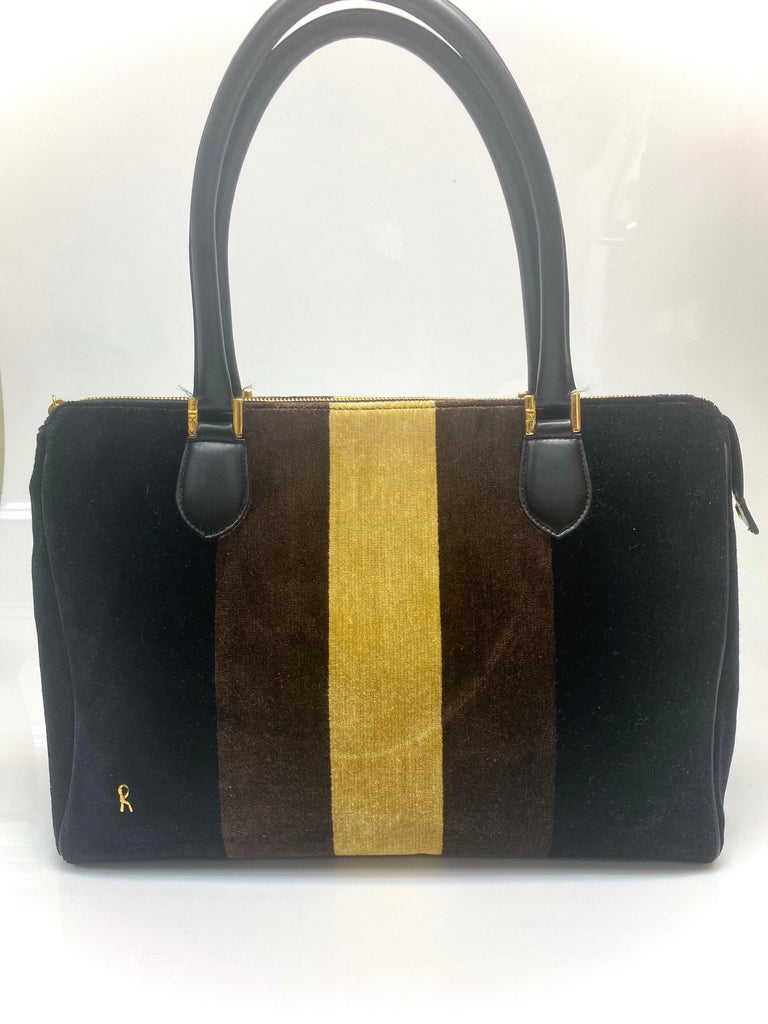 This Roberta Di Camerino Vintage Large Velvet tote bag is perfect for everyday luxury. The bag features black and brown gold canvas striped detailing. Gold hardware highlights the bag throughout and leather handles and leather lining. Bag is in