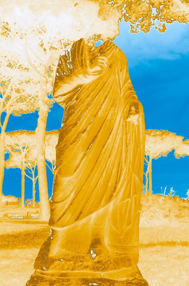 A contemporary color photograph by Roberta Fineberg of a classical Greco-Roman statue in Ostia Antica, the old port of Ancient Rome. The landscape in modern-style neon captures the spirit of the antiquities with Roman parasol pine trees and the