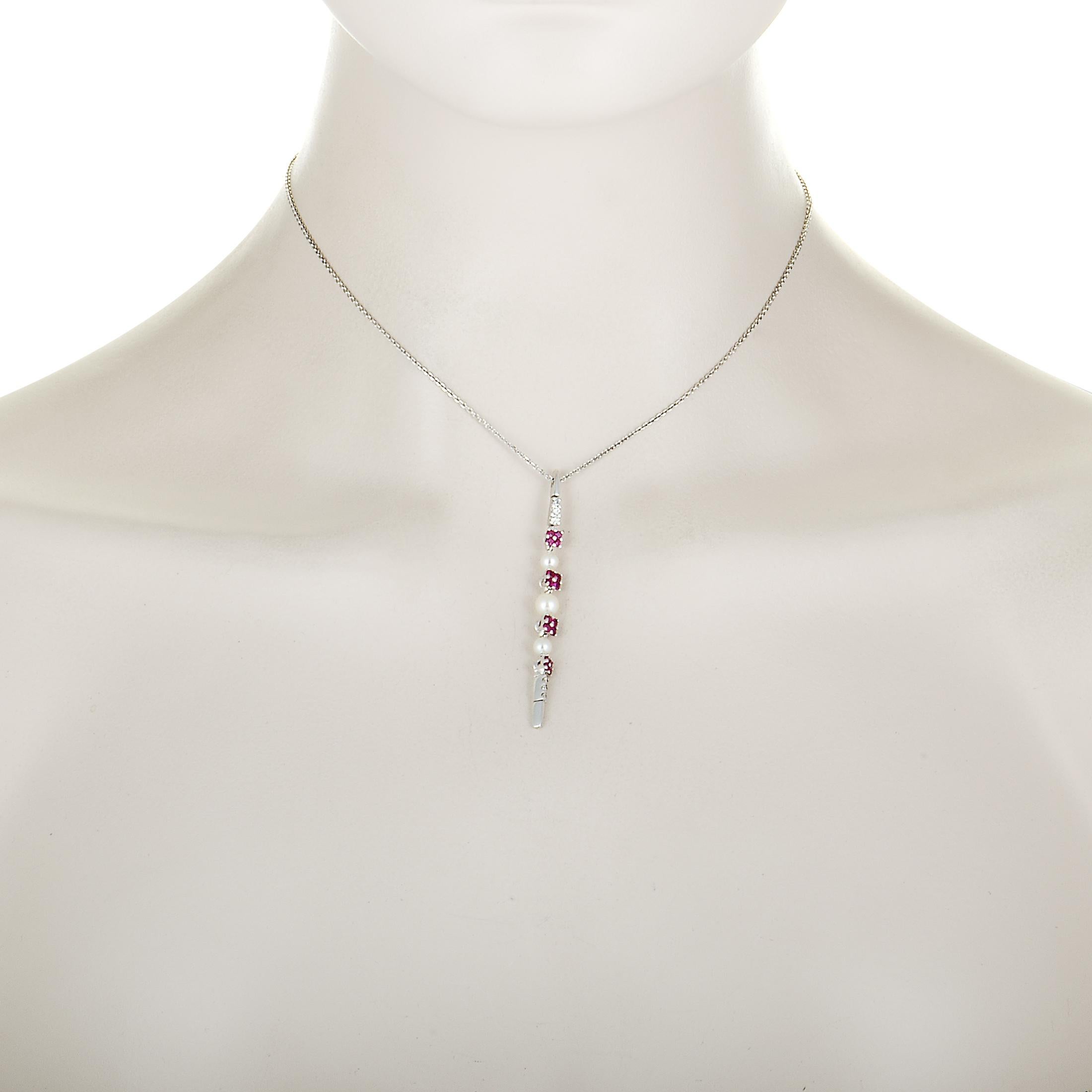 This Roberta Porrati necklace is made of 18K white gold and set with diamonds, rubies and pearls. The diamonds total 0.13 carats and the rubies amount to 0.73 carats. The necklace weighs 7.5 grams, boasting chain length of 15.00”, while the pendant