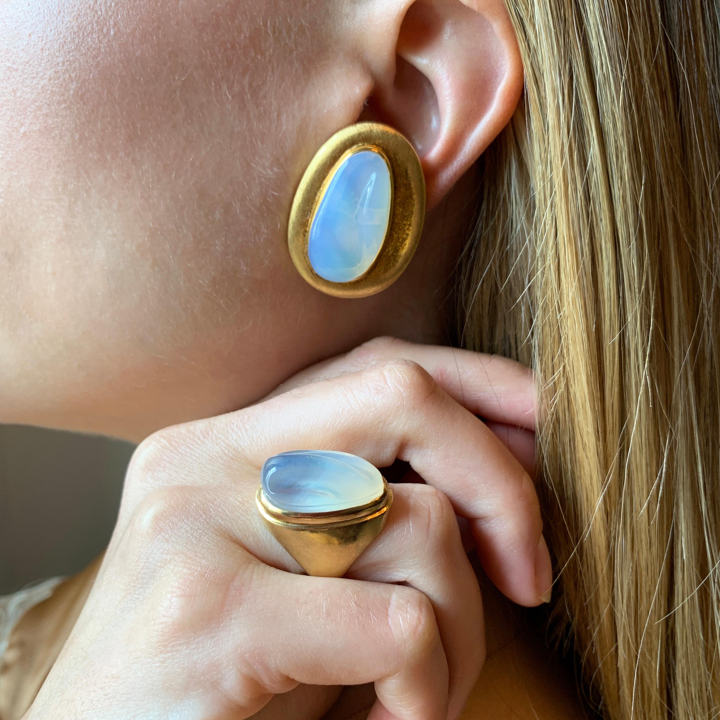 A medium sized pair of forma livre carved moonstone and 18 karat yellow gold clip on earrings by Roberto and Haroldo Burle Marx, c. 1970. 

The earrings are signed Burle Marx. Stamped 750, IND Bras, GB791. 

