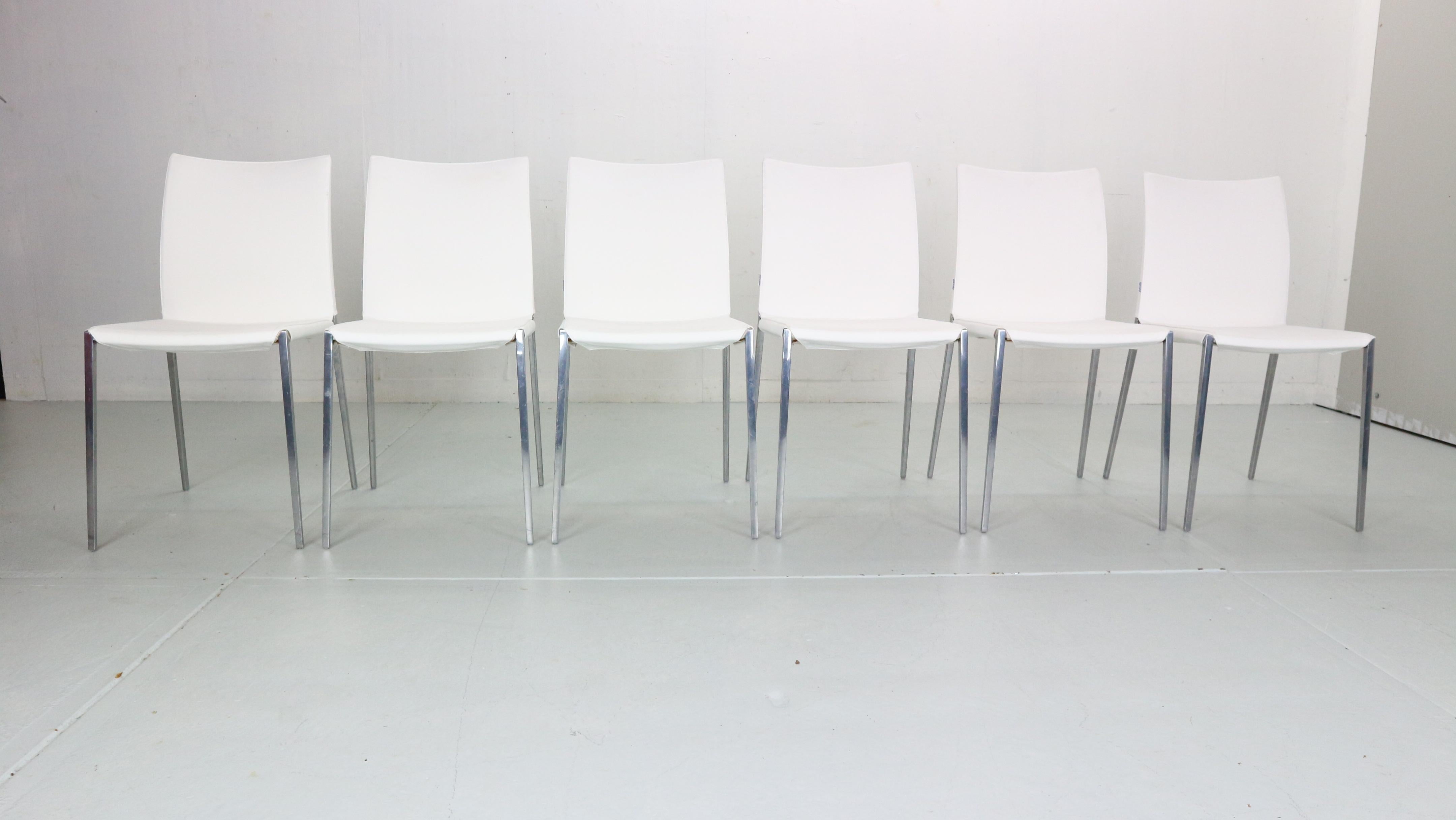 These contemporary 'Lia' white leather side chairs by Roberto Barbieri were presented by Zanotta in 1999. 
The chair proved to be innovative due to the increasingly advanced use of die-casting: the chair side is made of one single element in