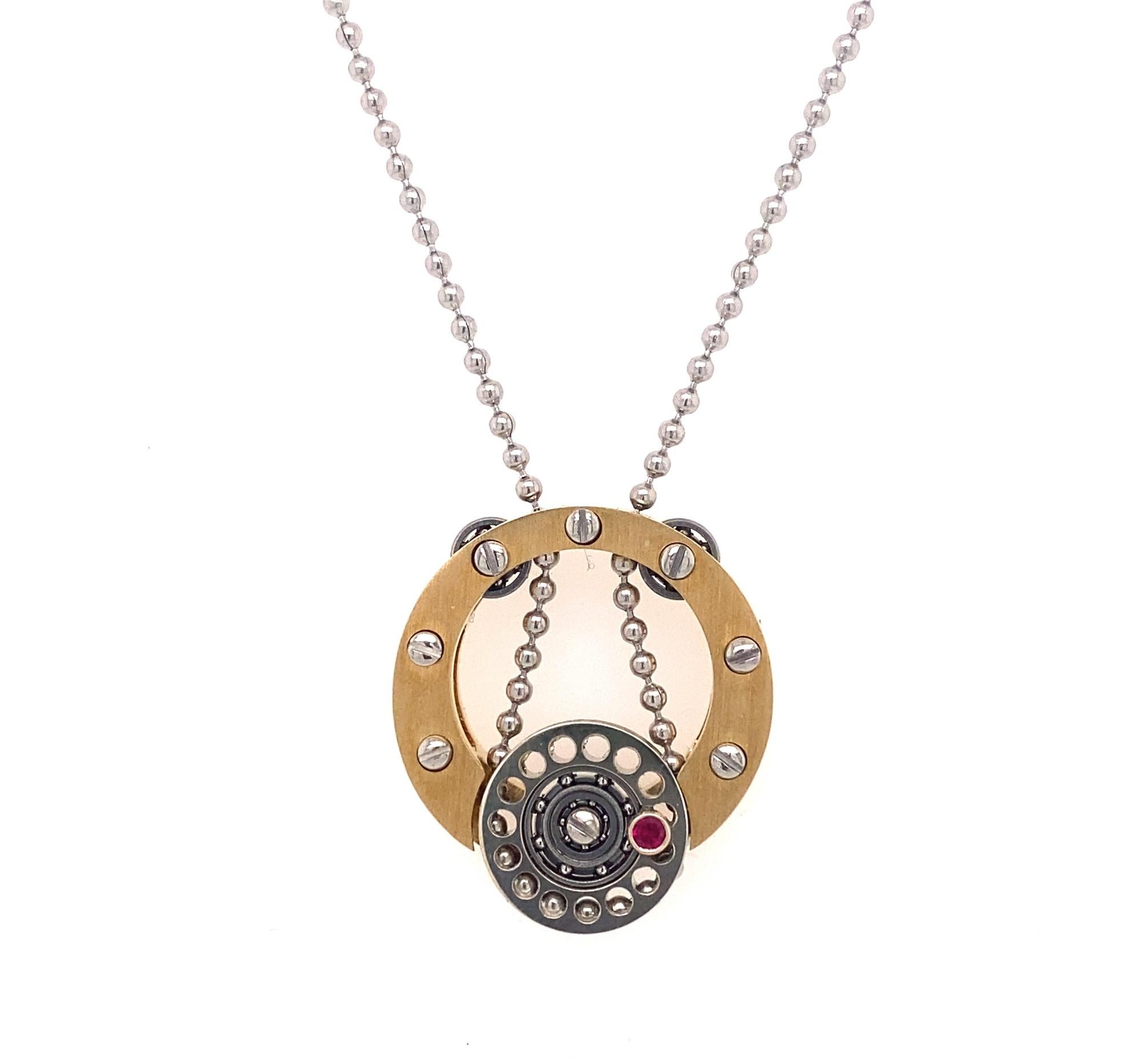 This is a stunning pendant by important jewelry designer Roberto Brun.  Roberto Brun specializes in making miniature machine jewelry.  The solid gold pendant has clock like gears that spin the center portion of the pendant when the chain moves.  The
