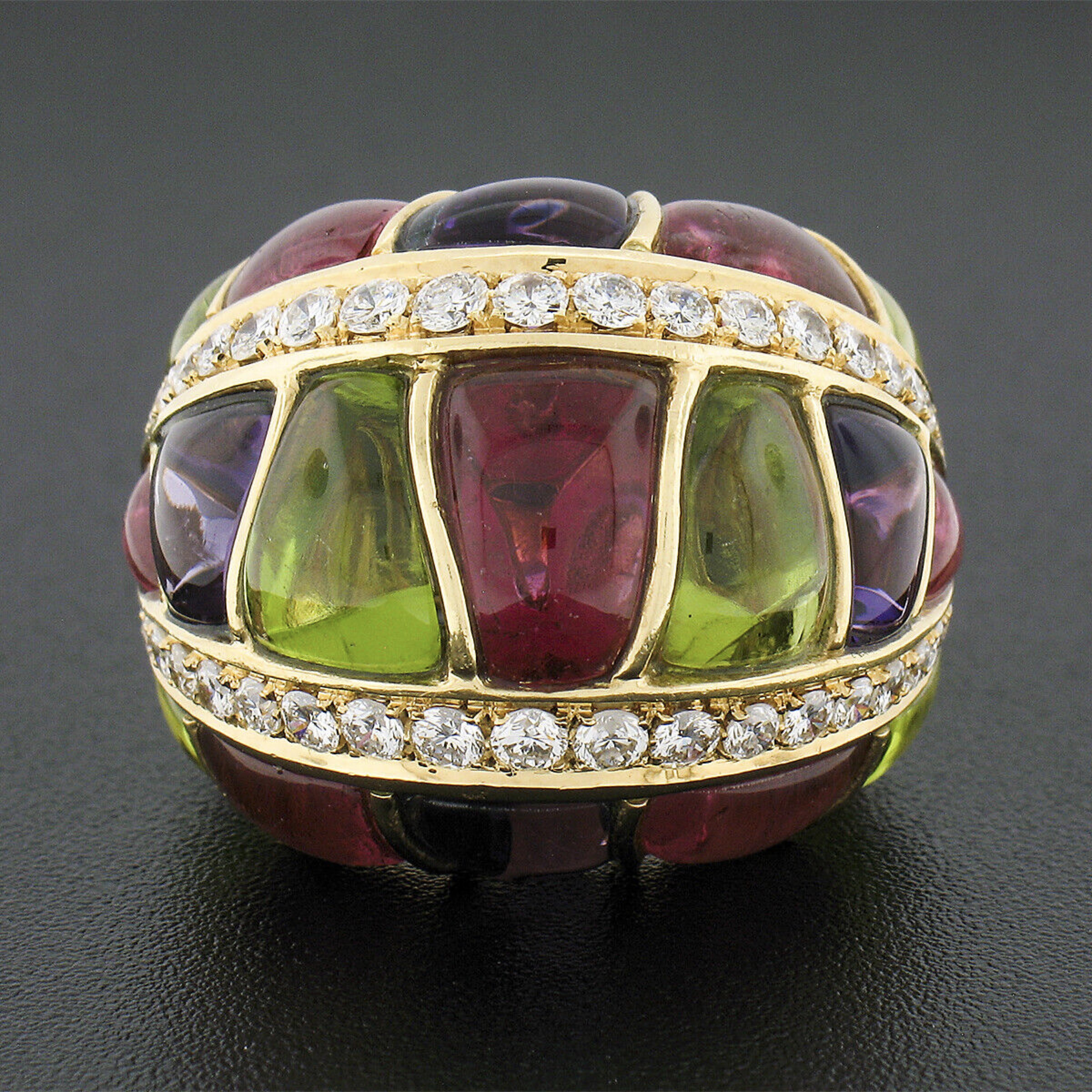 Here we have an absolutely magnificent and very well made cocktail ring that was crafted in Italy from solid 18k yellow gold and designed by Roberto Casarin. It features a domed top that is set with the most gorgeous natural peridot, amethyst, and
