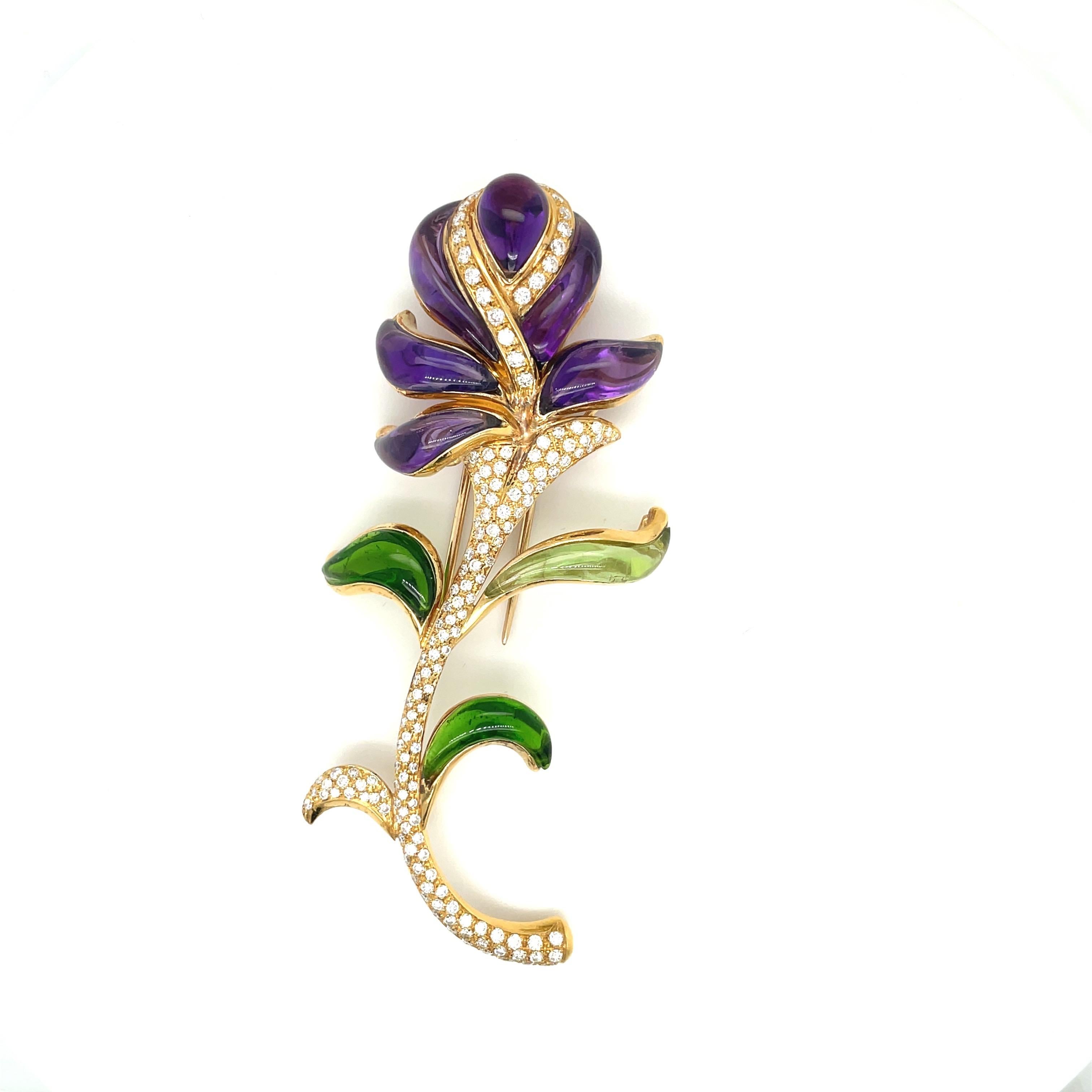 Made for Cellini by Roberto Casarin, this timeless and elegant yellow gold brooch, with natural amethyst petals, green tourmaline leaves and diamond stem is the perfect brooch for any occasion. Made in Italy by Roberto Casarin, and stamped Cellini