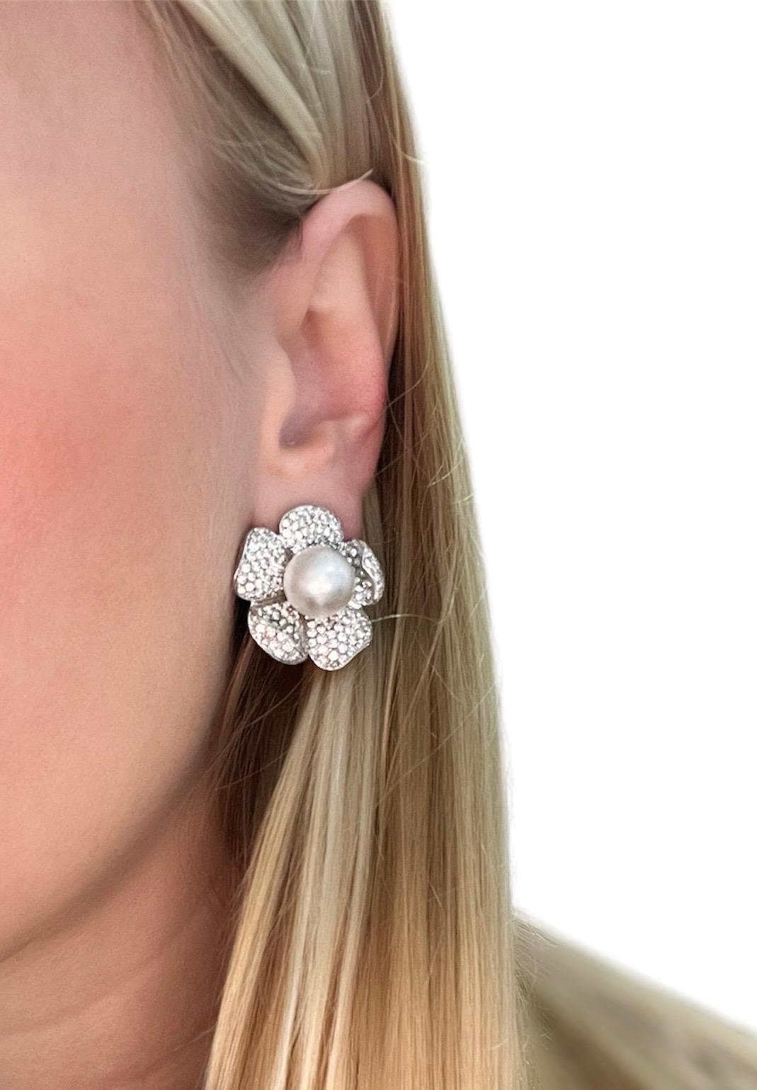 These beautifully crafted flower earrings by Italian designer Roberto Casarin contain two lustrous cultured South Sea pearls measuring 11.45 mm surrounded by pave set top quality round brilliant cut diamond petals weighing approximately 6.50 carats