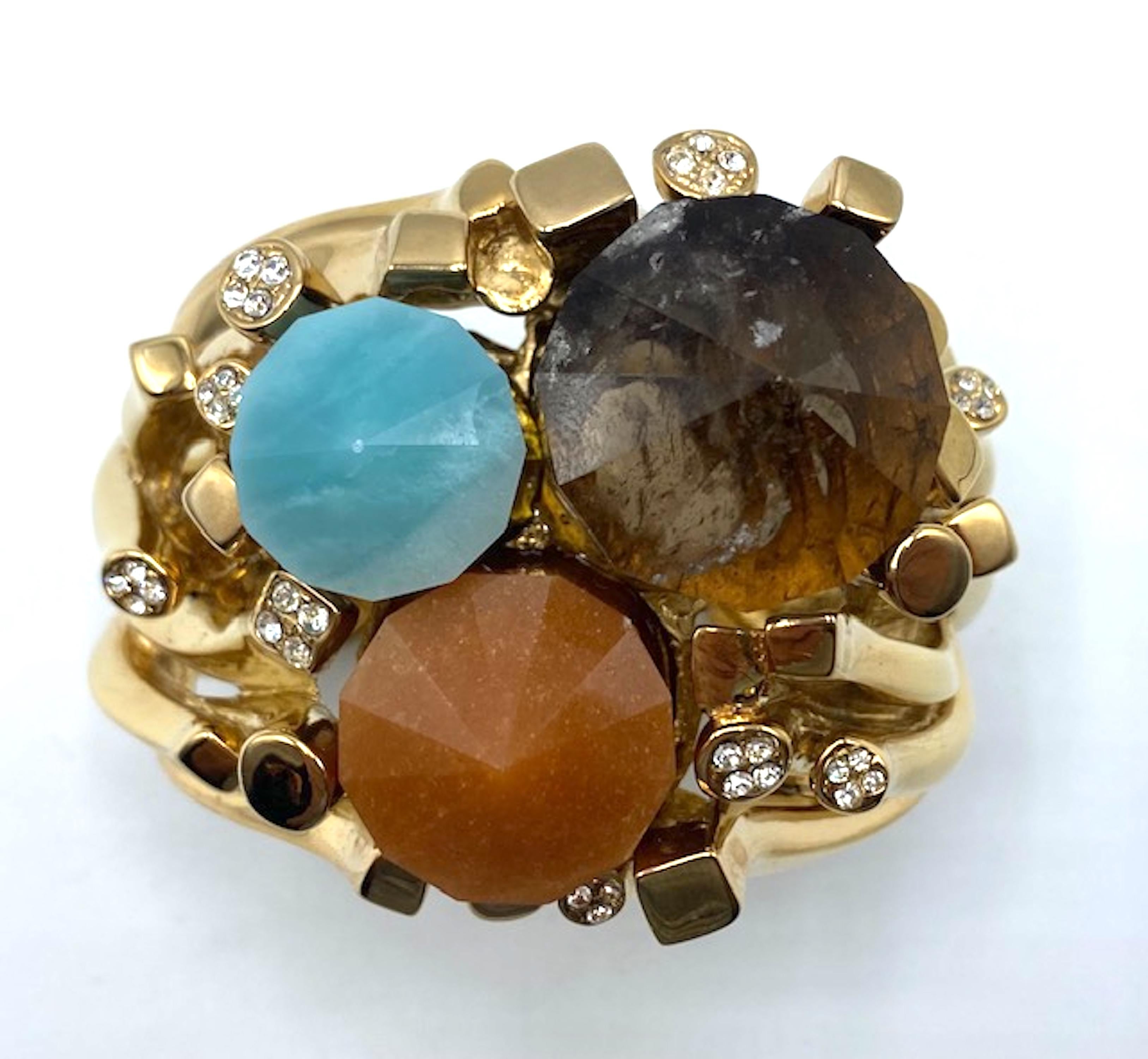 Presented is a beautiful example of the artistry of Roberto Cavalli jewelry. The abstract and modernist sculptural bracelet was made from a solid casting. It is gold plate with three semiprecious natural quartz pointed rods erupting from the center.