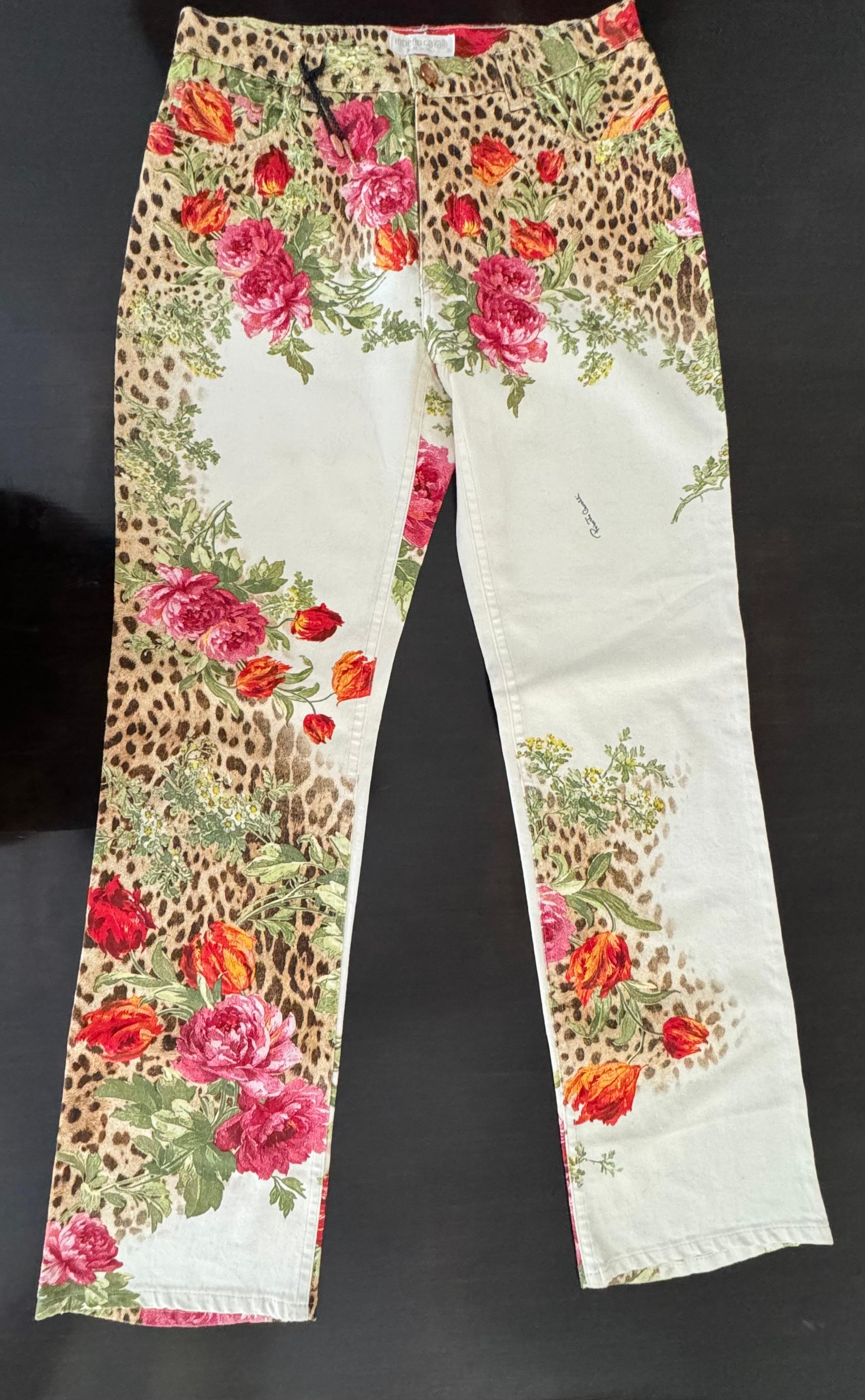 Roberto Cavalli 1990’s Leopard and Rose Print Mid Rise Jeans - Size Large  These iconic Cavalli Printed Jean design from the late 90’s are a true collectors piece. The pants are mainly ivory with leopard and multi colored roses/flowers throughout.