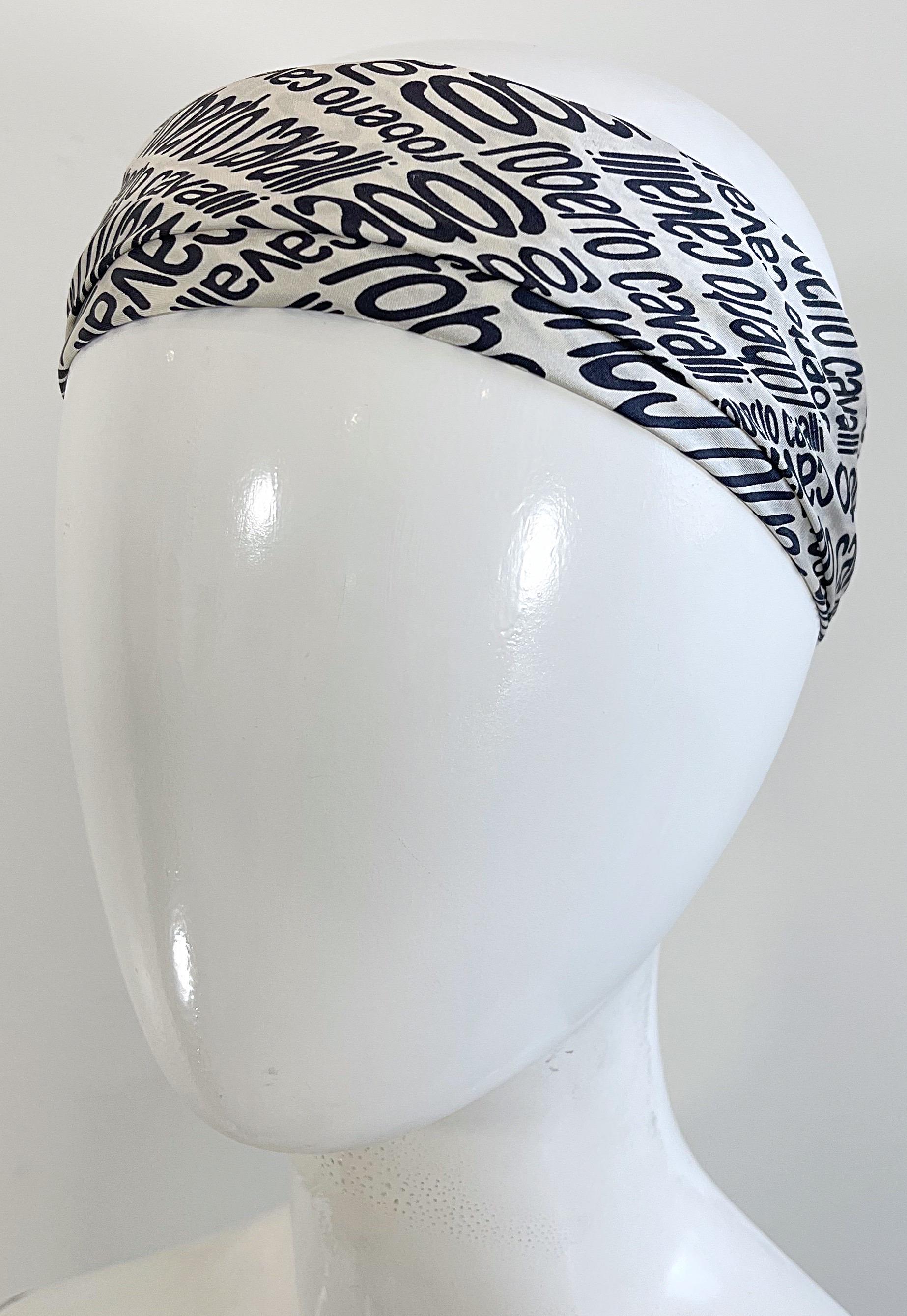 Early 2000s brand new with tags vintage Roberto Cavalli black and white silk scarf ! Boarder has pale pink, and a giraffe animal print. Hand rolled edges. Wear around the neck, or as a headscarf. 
In great unworn condition, with original store tags