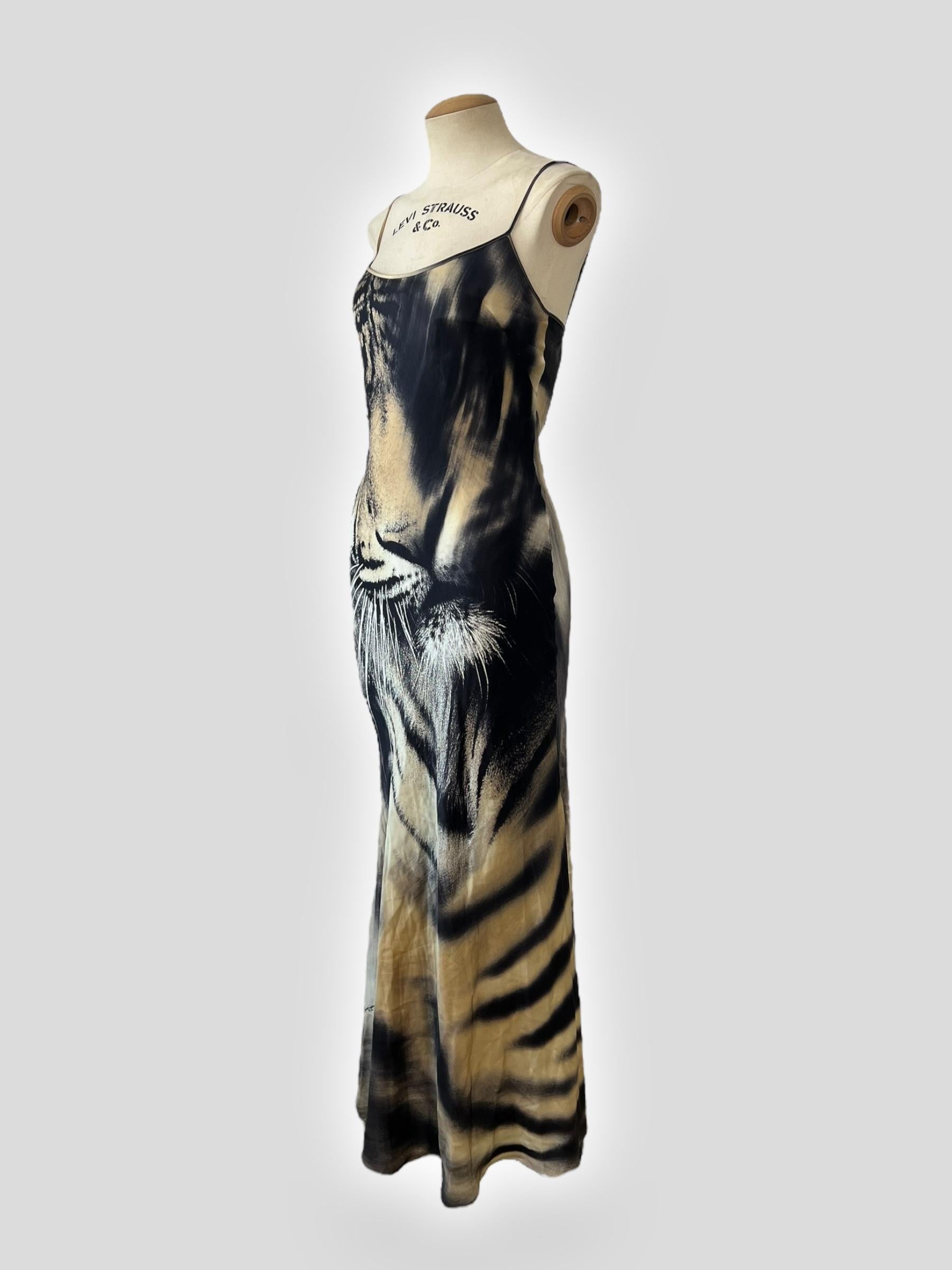 A show-stopping vintage Roberto Cavalli dress, featuring the designer’s iconic tiger print, as seen on Cindy Crawford on the early 2000s runway. Crafted from fluid silk, this maxi dress drapes beautifully over the body with a bias-cut silhouette,