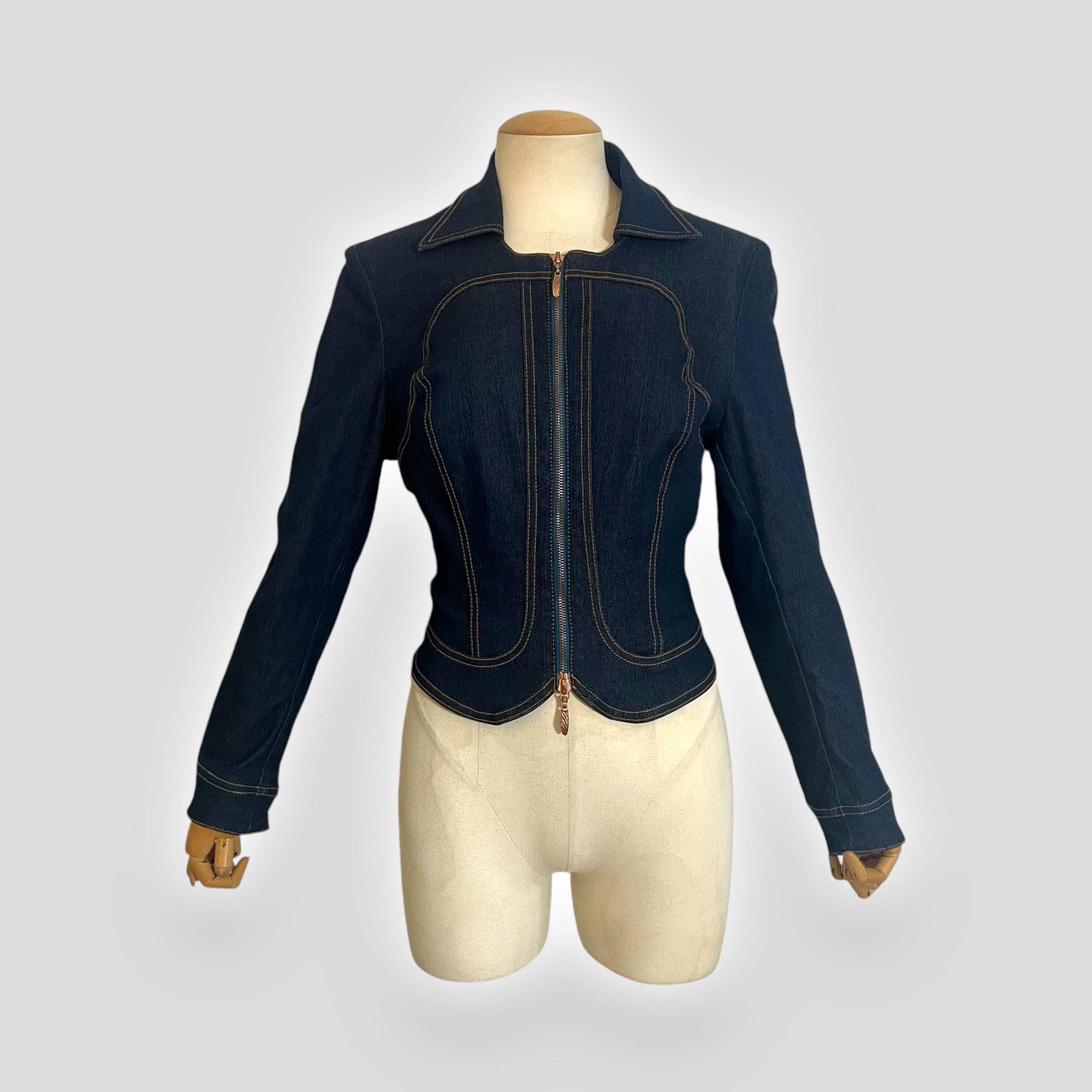  

This Roberto Cavalli jacket from the Spring 2002 collection features a structured, corset-like silhouette with contrasting topstitching and a dual zipper closure. A unique detail is the adjustable waist at the back, allowing for a customized fit.
