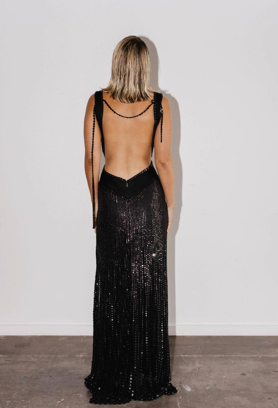 Roberto Cavalli’s Maxi Sequin Gown is an unforgettable showpiece from the designer’s 2007 collection. Cut from soft cupro fabric and densely embellished with paillettes, it creates a liquid-shine effect that cascades down the body in a mesmerising
