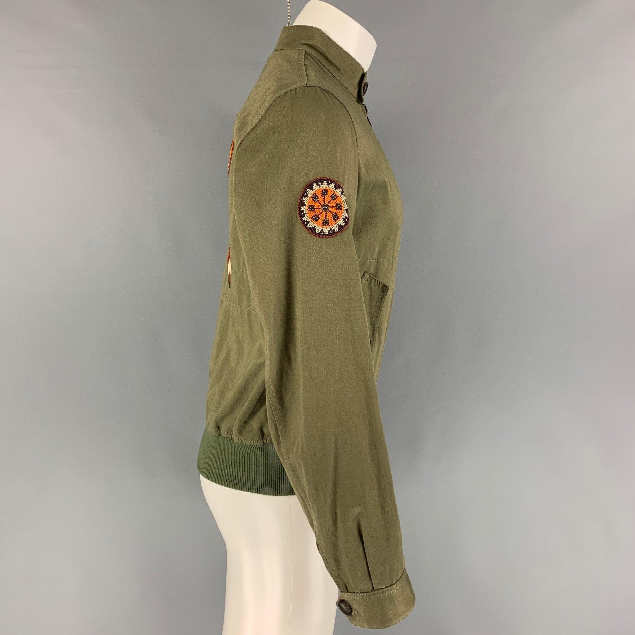 ROBERTO CAVALLI 2016 jacket comes in a green cotton featuring a loose fit, ribbed hem, beaded sleeve details, top stitching, flap pockets, back beaded animal design, anda full zip up closure. Made in Italy.
Very Good
Pre-Owned Condition. 

Marked:  