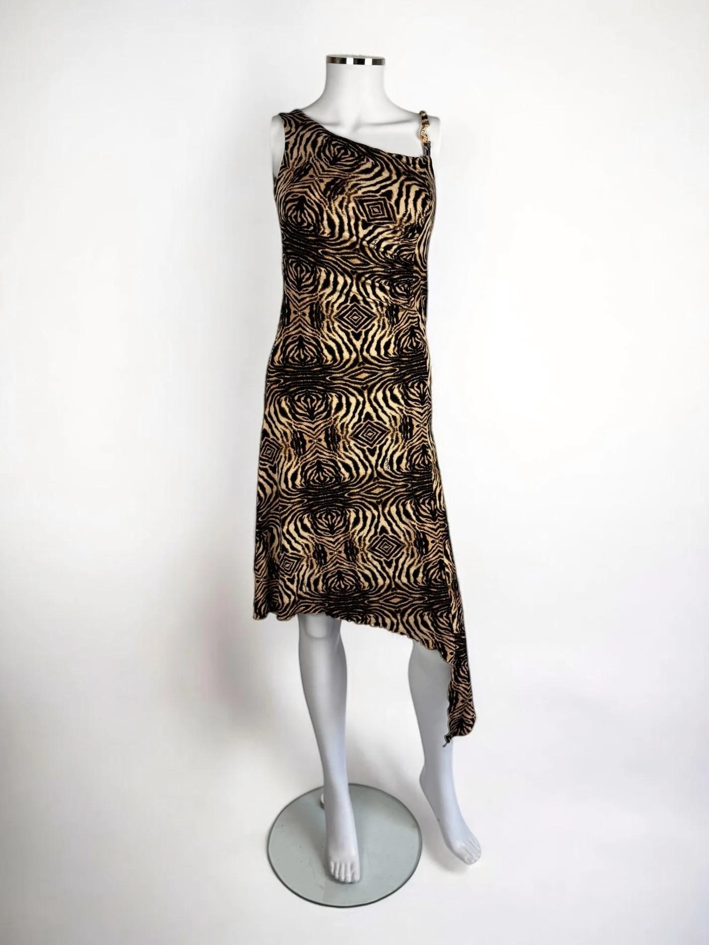 Roberto Cavalli abstract animal print dress, 2006
Asymmetric neckline and hem of differing lengths
One shoulder accented by a gold toned snake with encrusted diamantés
94% viscose 6% elastane 
Size: L


