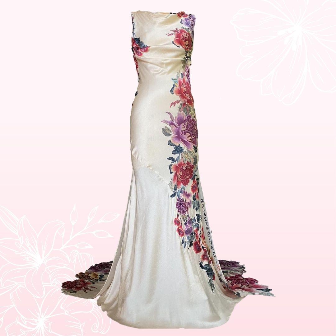 Roberto Cavalli - Delicate peach Asian inspired evening gown. Dramatic, colorful and breathtaking best describes this gown.  The upper bodice of the dress has a cowl neckline.  The back of the dress is cut low with a draping cowl backline.  The fit