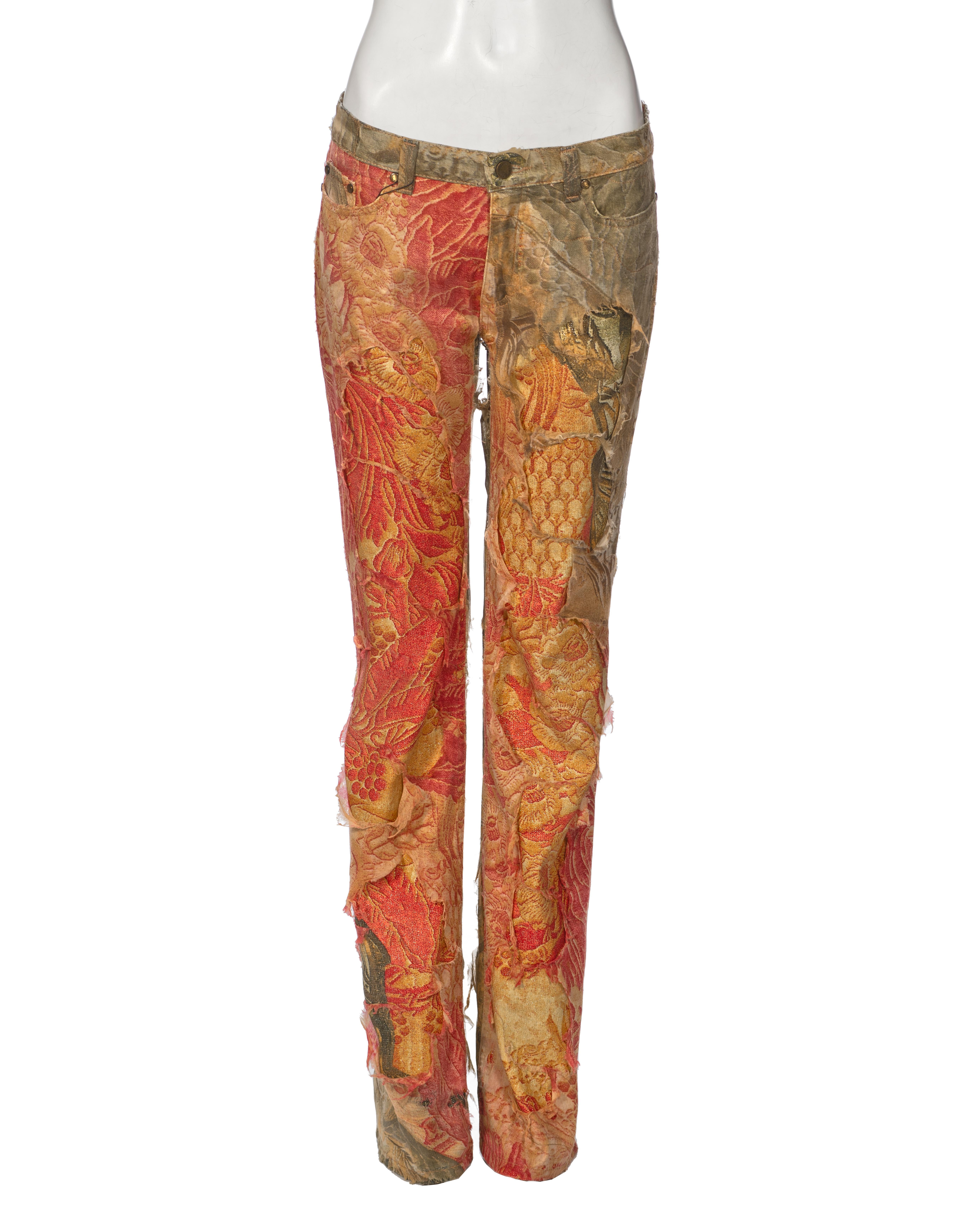 ▪ Roberto Cavalli Runway Pants
▪ Fall-Winter 2001
▪ Sold by One of a Kind Archive
▪ Cotton pants with distressed silk overlay
▪ Baroque and nature-inspired design
▪ Button and zip fly closure
▪ Straight leg
▪ Material: Cotton, Silk
▪ Colour:
