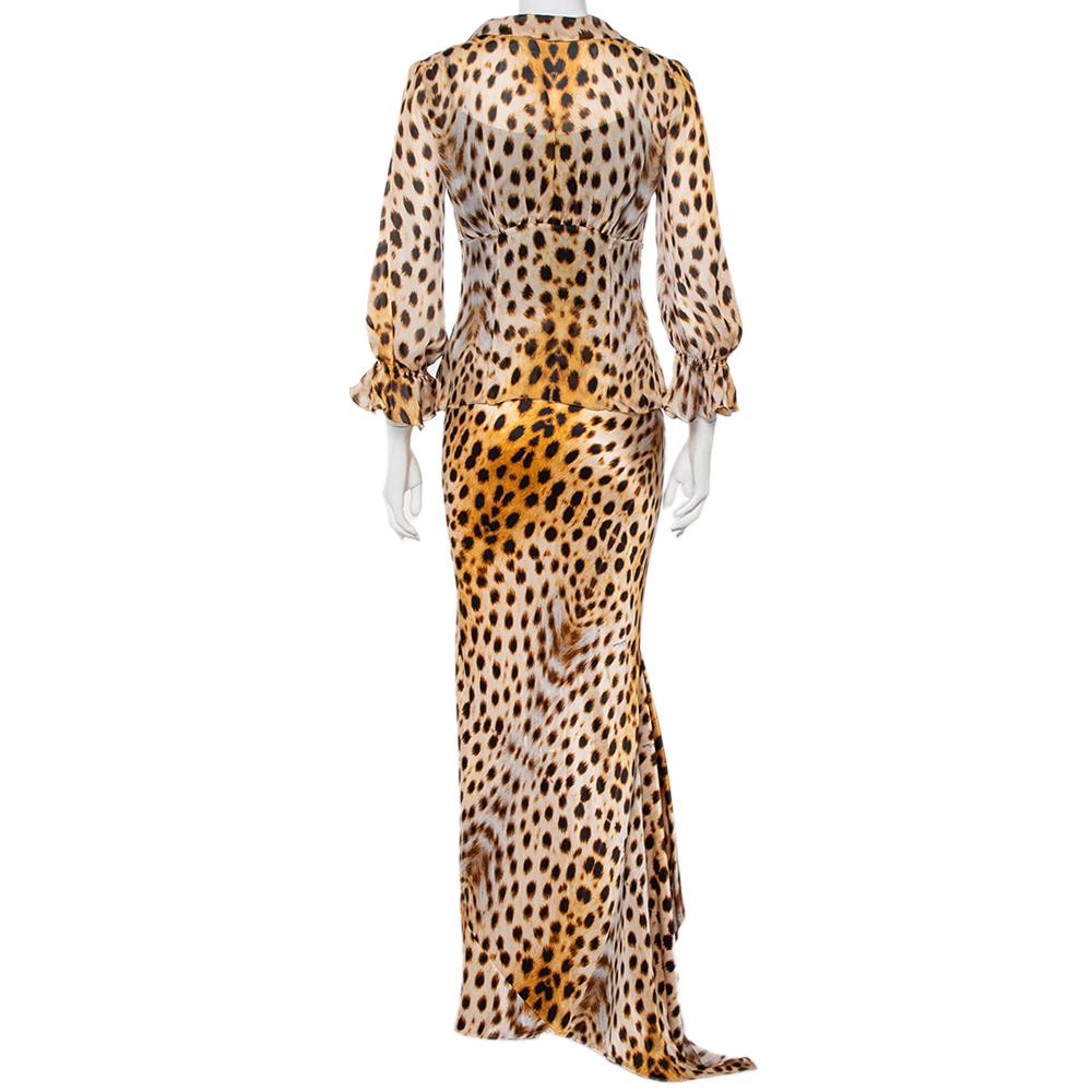 Roberto Cavalli's love for animal prints comes alive in this stunning set of a shirt and maxi skirt. They are tailored from beige-hued sheer silk then elevated by animal prints that are nothing but timeless. The skirt has an asymmetric hem while the