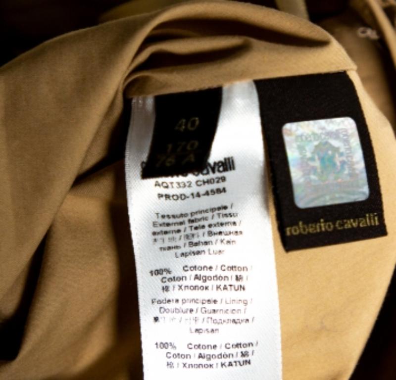 Los elegantes diseños y siluetas de Roberto Cavalli se hacen patentes en esta minifalda. Fabricada en algodón, luce un tono beige y un diseño plisado. La falda presenta un intrincado bordado en la parte delantera y trasera y se completa con un