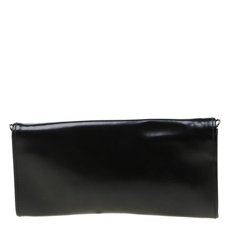 This gorgeous creation by Roberto Cavalli is crafted from the finest leather in the shade of black. The clutch features crystal embellishments on the front flap with fabric interiors that are designed with a small pocket to keep your essentials