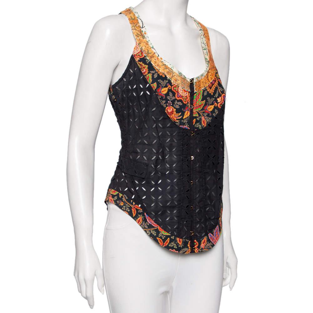 Designed by Roberto Cavalli  this gorgeous vest has been tailored to grant nothing but style and panache. It is made from black cotton fabric  which is highlighted with eyelet and sequin embellishments. It features a shapely neckline and a hook type
