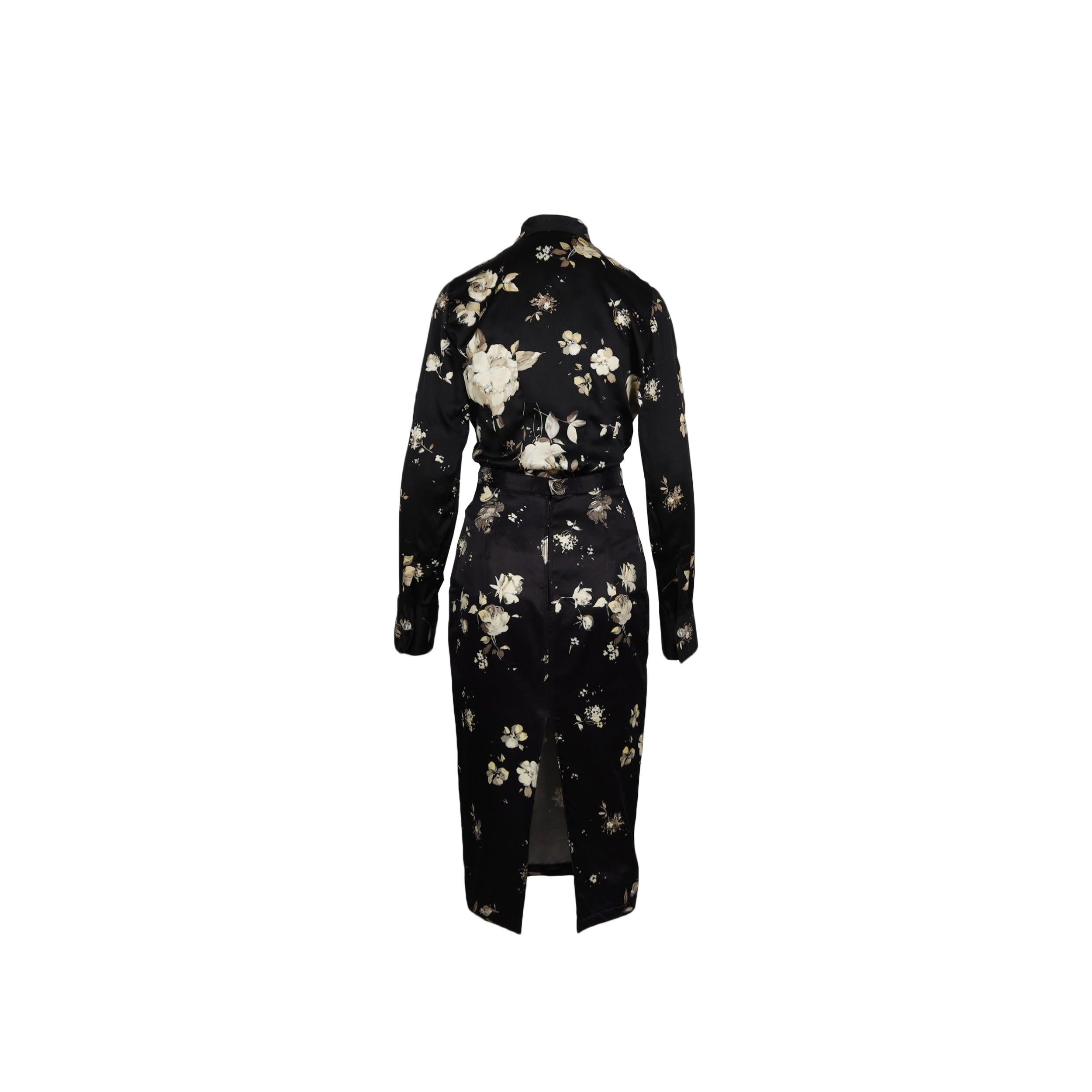Bring back the floral glamour with the Roberto Cavalli black flower-printed skirt and top suit of the Fall/Winter 2006 collection. The full-sleeved shirt features drop shoulders and can be tightened with transparent buttons. The pencil skirt