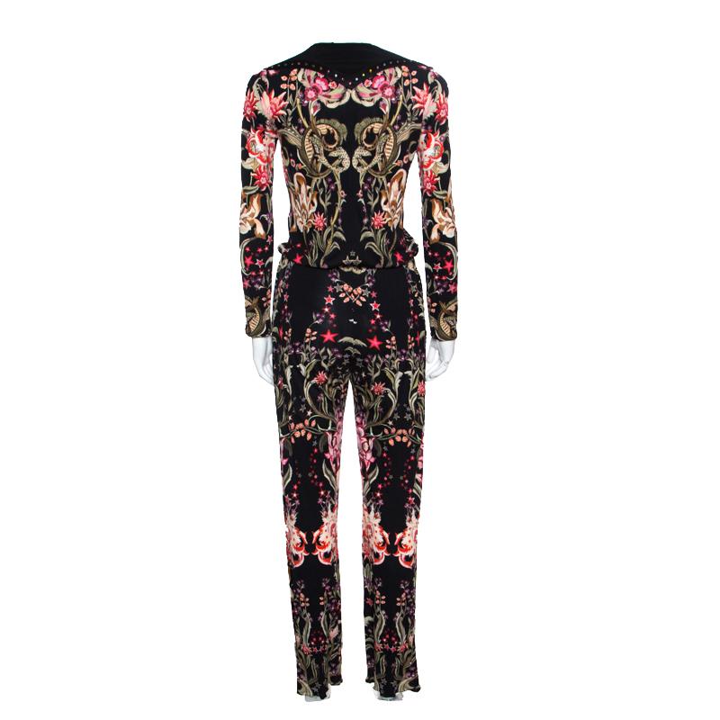 Exuding a chic style, this jumpsuit from the house of Roberto Cavalli is a stylish piece of clothing that doesn't compromise on comfort. It is styled with a galaxy garden print all over with a classy black base. Designed with a plunging V-neckline,