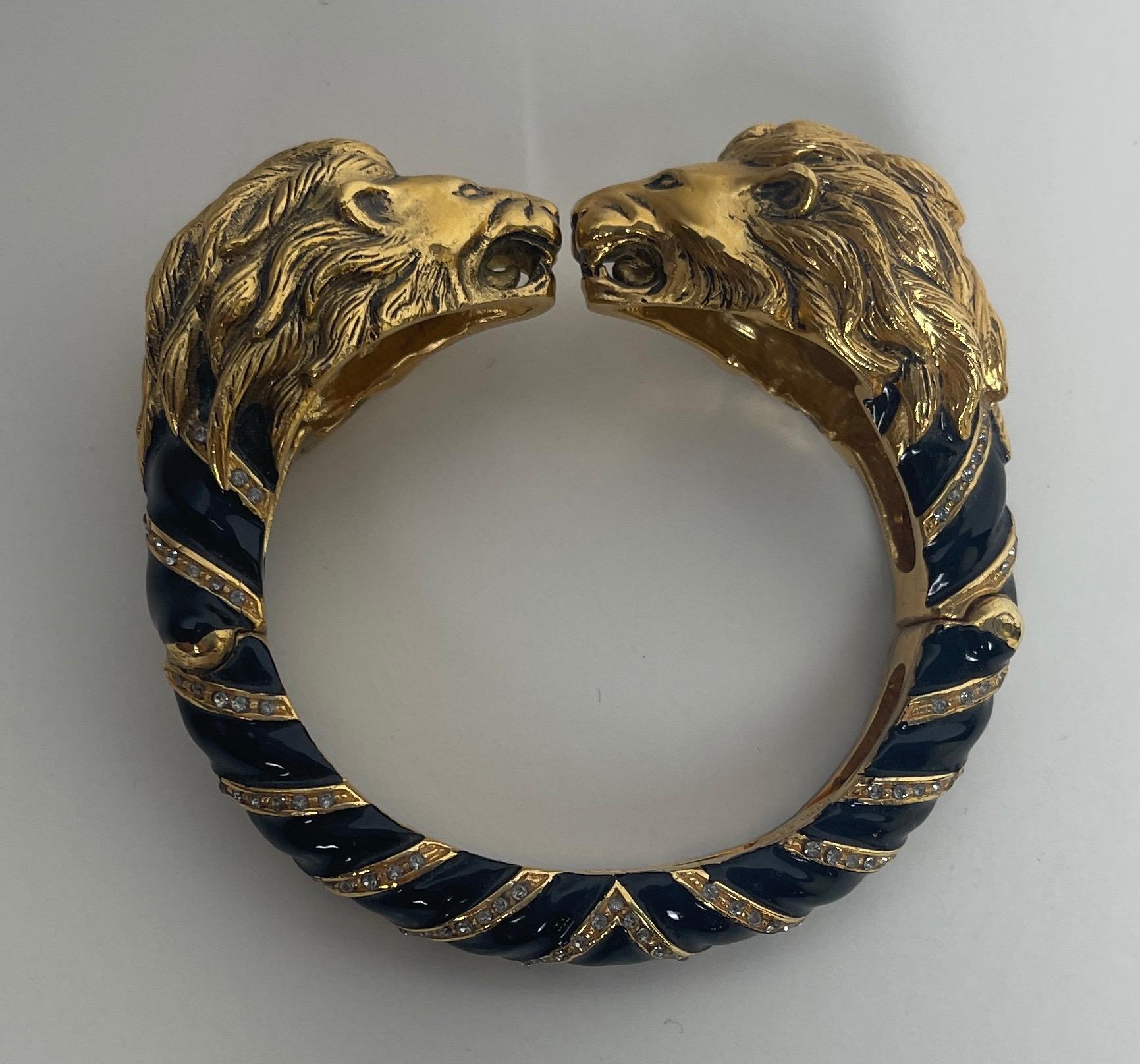 Roberto Cavalli Lion Head Bangle Bracelet

Materials: metal, enamel, crystals
Hallmarks: Roberto Cavalli MADE IN ITALY
Closure/Opening: Double hinge
Overall Condition: Excellent pre-owned condition with light wear
Estimated Retail: $325 plus