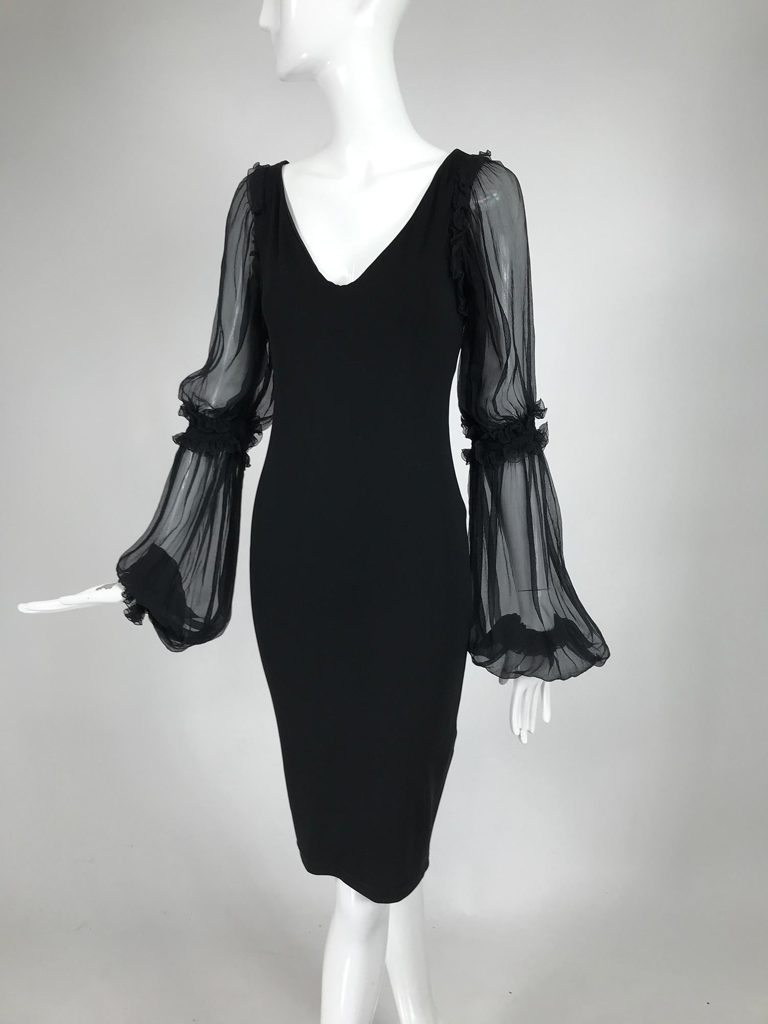 Roberto Cavalli black stretch jersey dress with gathered black chiffon sleeves. Fitted stretch dress has a v neckline and long sheer, full chiffon sleeves that are gathered at the elbow and wrist with cased elastic. The dress is self lined. Pull on