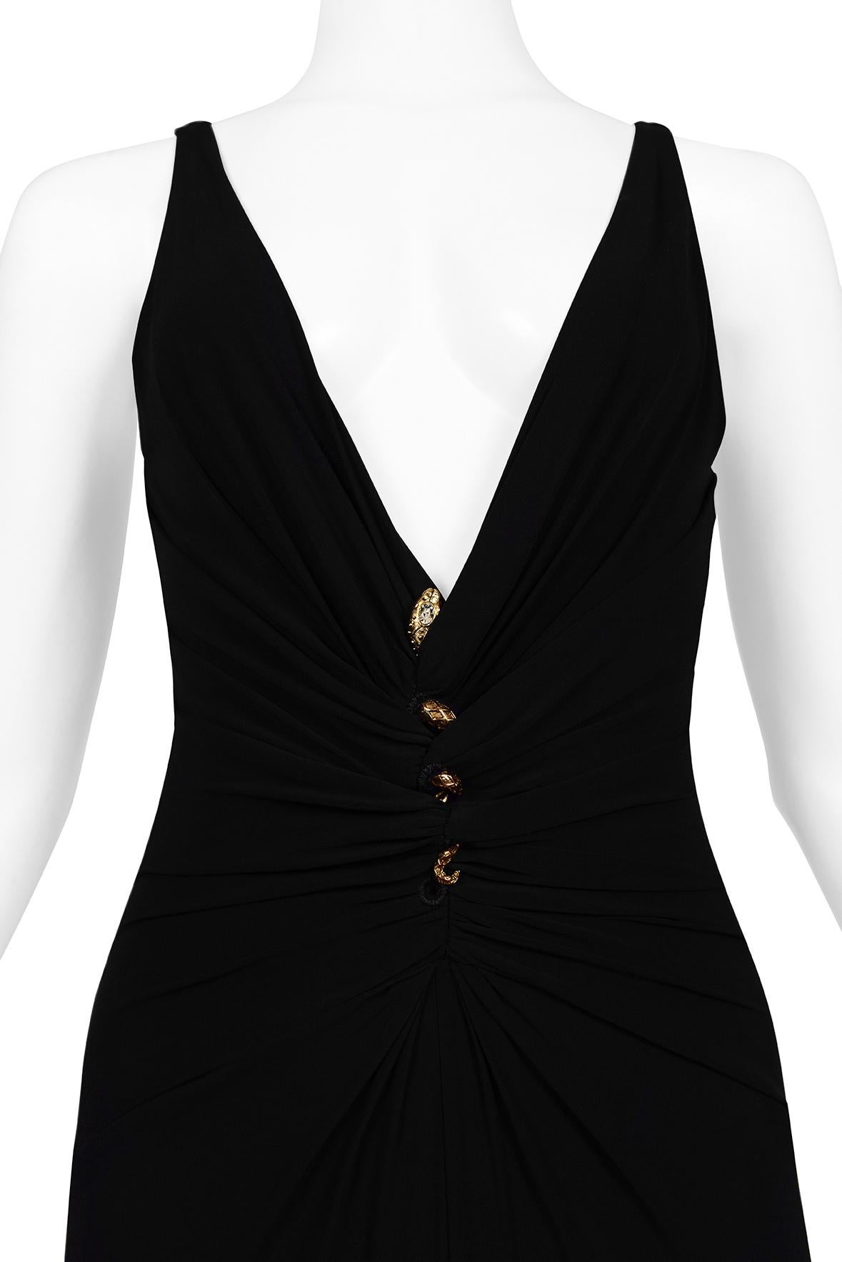 Resurrection Vintage is delighted to offer a vintage black Roberto Cavalli gown featuring a deep v-neck, gathered fabric laced with gold snake hardware at center front, slinky fit, and dramatic evening gown length.

* Roberto Cavalli
* Size US 4
*