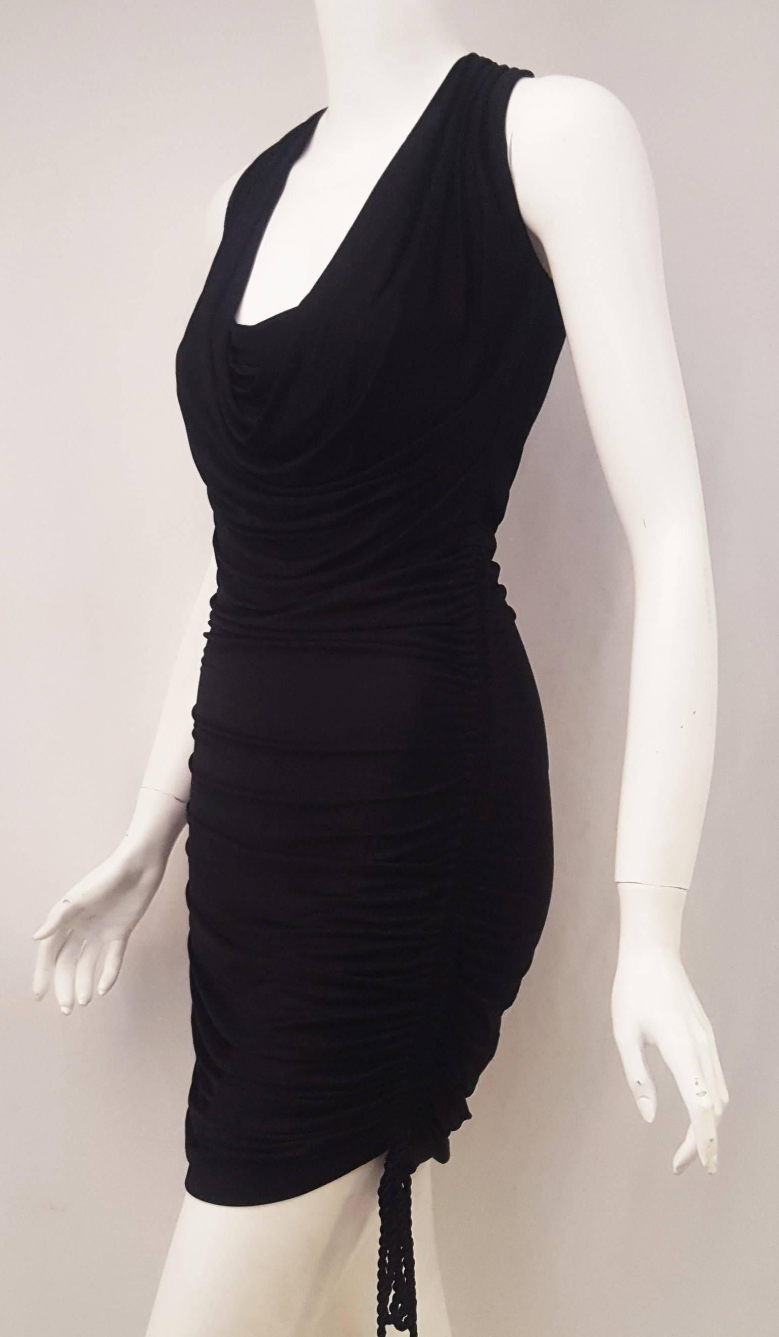 Roberto Cavalli black knit viscose dress has a low scoop collar that can be gathered from just below the bust to the hem by cords at each side to become a mini or midi dress.  This Roberto Cavalli unlined dress brings sexy back!  Dress it up or