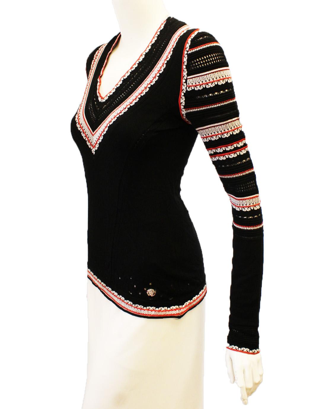 Roberto Cavalli black long sleeve stretch knit top decorated with white and red ribbed knit on the V neck and down the sleeves creating a striped pattern.  Also, around the cuffs and hemline with the red and white creating a ruffle effect.  This top