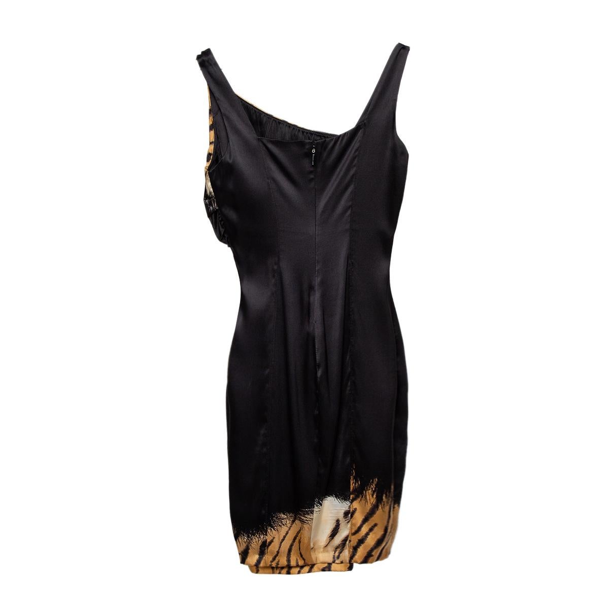 Sensuous and bold are two words that pretty much define this Roberto Cavalli dress. It is a beautiful creation cut from quality satin silk fabric. The dress features a draped design, a sleeveless silhouette, and animal-printed panels.

