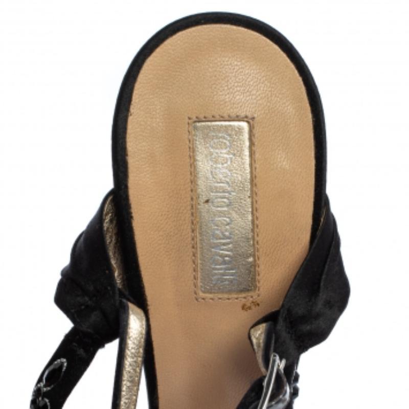 Make a bold style statement as you flaunt these Roberto Cavalli sandals! They come crafted from rich satin in a classic black shade and feature an open-toe silhouette. They have been styled with exquisitely embellished cross straps on the vamps and