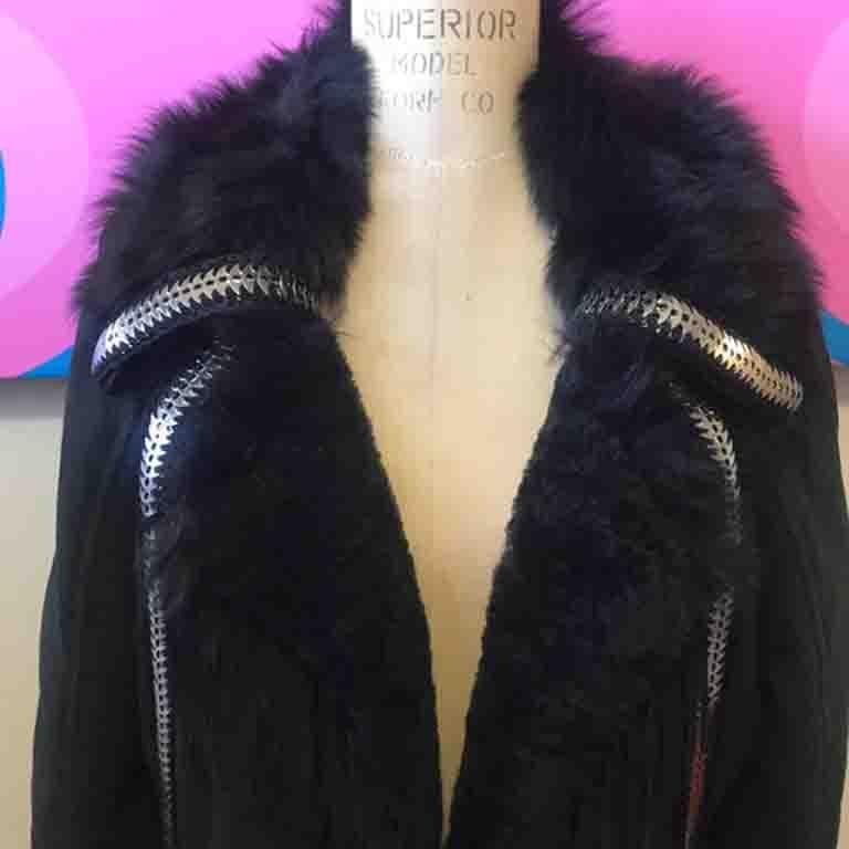 This unique black shearling jacket has fringe detail and chain mail trim! Pair with black skinny pants and boots and a turtleneck sweater for the perfect cold weather look! NYC anyone? RUNWAY Jacket
Size 44
Across the chest - 21 1/2 inches
Across
