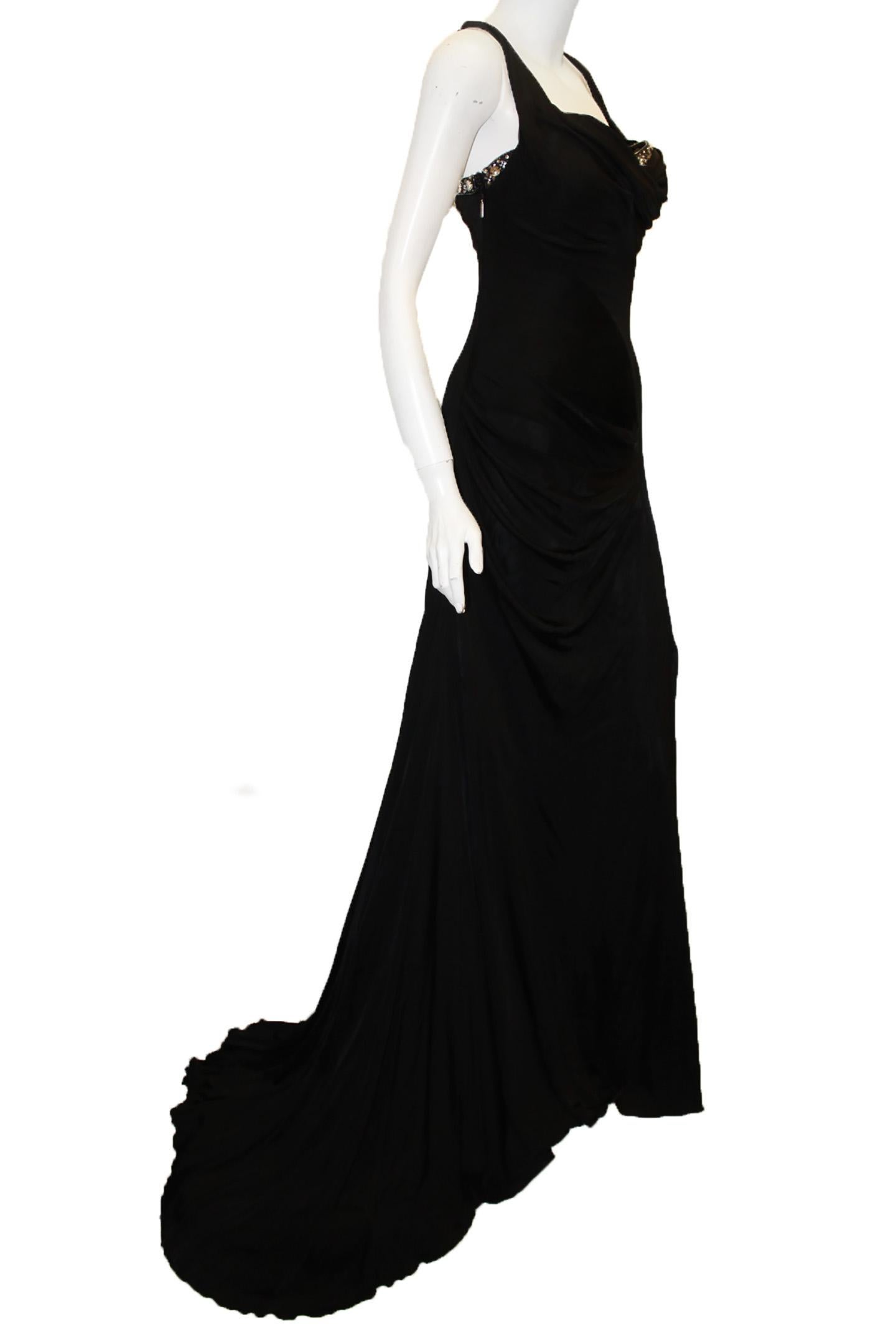 Roberto Cavalli black jersey long evening dress is embroidered with clear crystals of varying shapes around asymmetrical neckline for a dramatic statement.  With twisted knot straps and open left seam slit accentuating the drama.  This gown has a