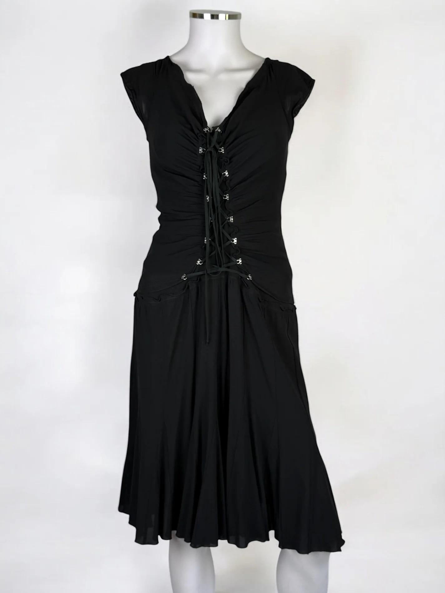 Roberto Cavalli black silk corset dress, 2003
Mid-length
Short sleeves
Adjustable corset detail at front giving an amazing ruched shape
96% silk 4% lycra
Good vintage condition — note: it is possible that at one point there might have been corset