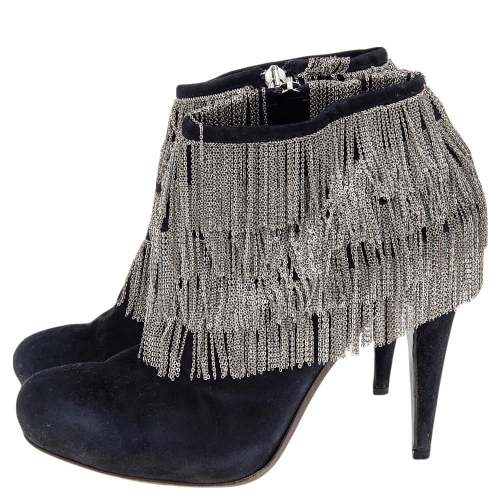 These glamorous boots by Roberto Cavalli are perfect for a special evening. Crafted from suede, these black boots are styled with round toes. They have dangling chain trims from the topline. They are finished with silver-tone hardware, 12 cm heels,